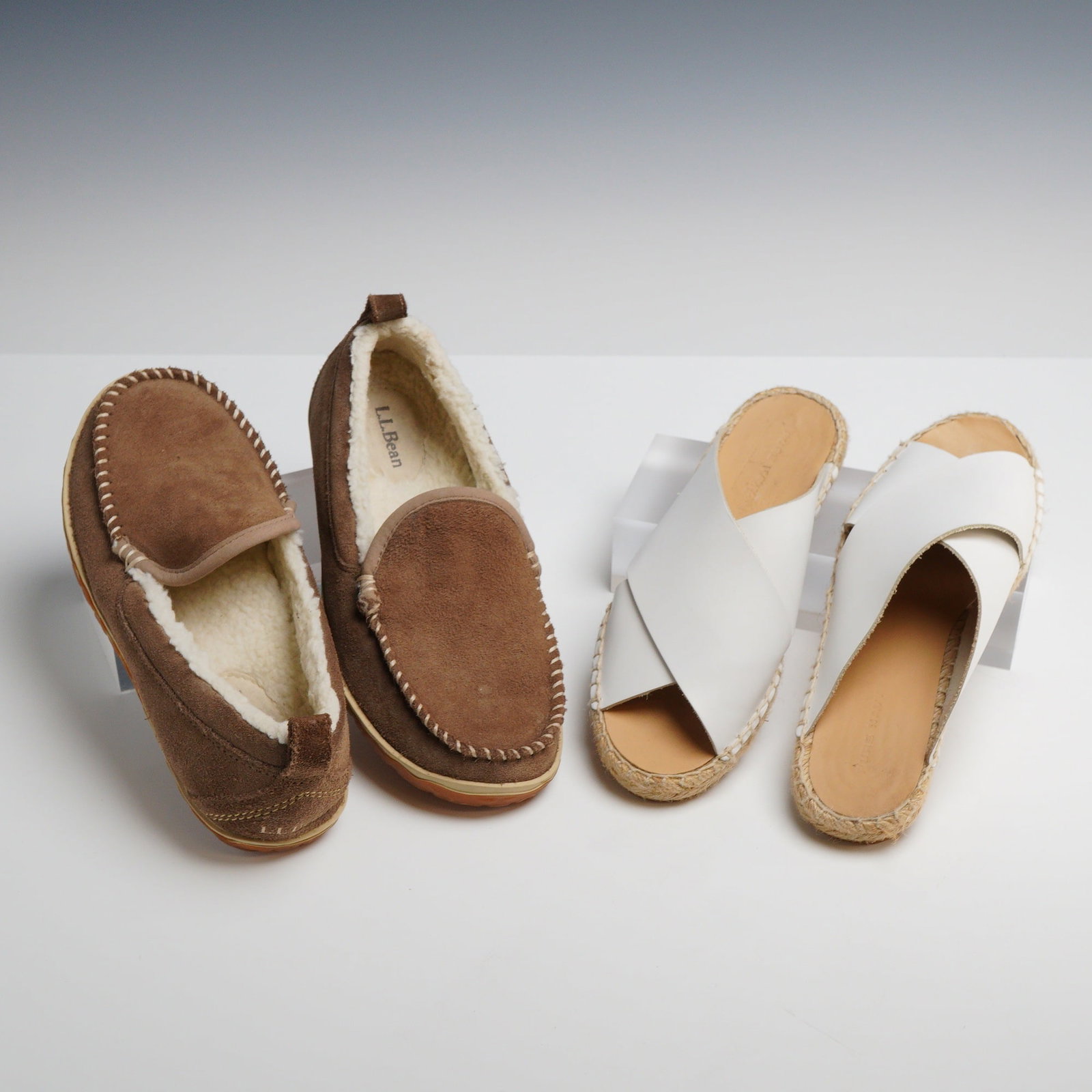 A Pair of L.L.Bean Wicked Good Venetian Slippers and Pure Navy Espadrille Slides: This lot includes two pairs of women's footwear. The first pair is L.L.Bean Wicked Good Venetian moccasin-style slippers, size 6 Medium. These slippers feature a brown suede leather upper with whipsti