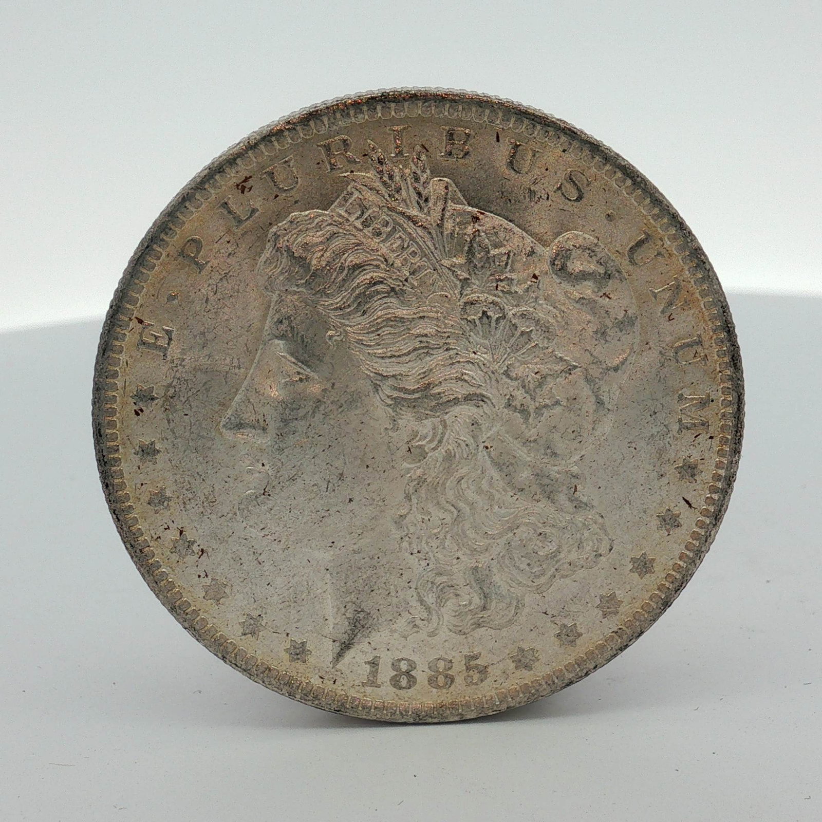 1885-O US Morgan Silver Dollar Coin Circulated: US 1885-O Morgan silver dollar struck at the New Orleans Mint. The coin is composed of 90 percent silver. The Morgan dollar obverse features the date 1885 and the motto E PLURIBUS UNUM. The Morgan dol