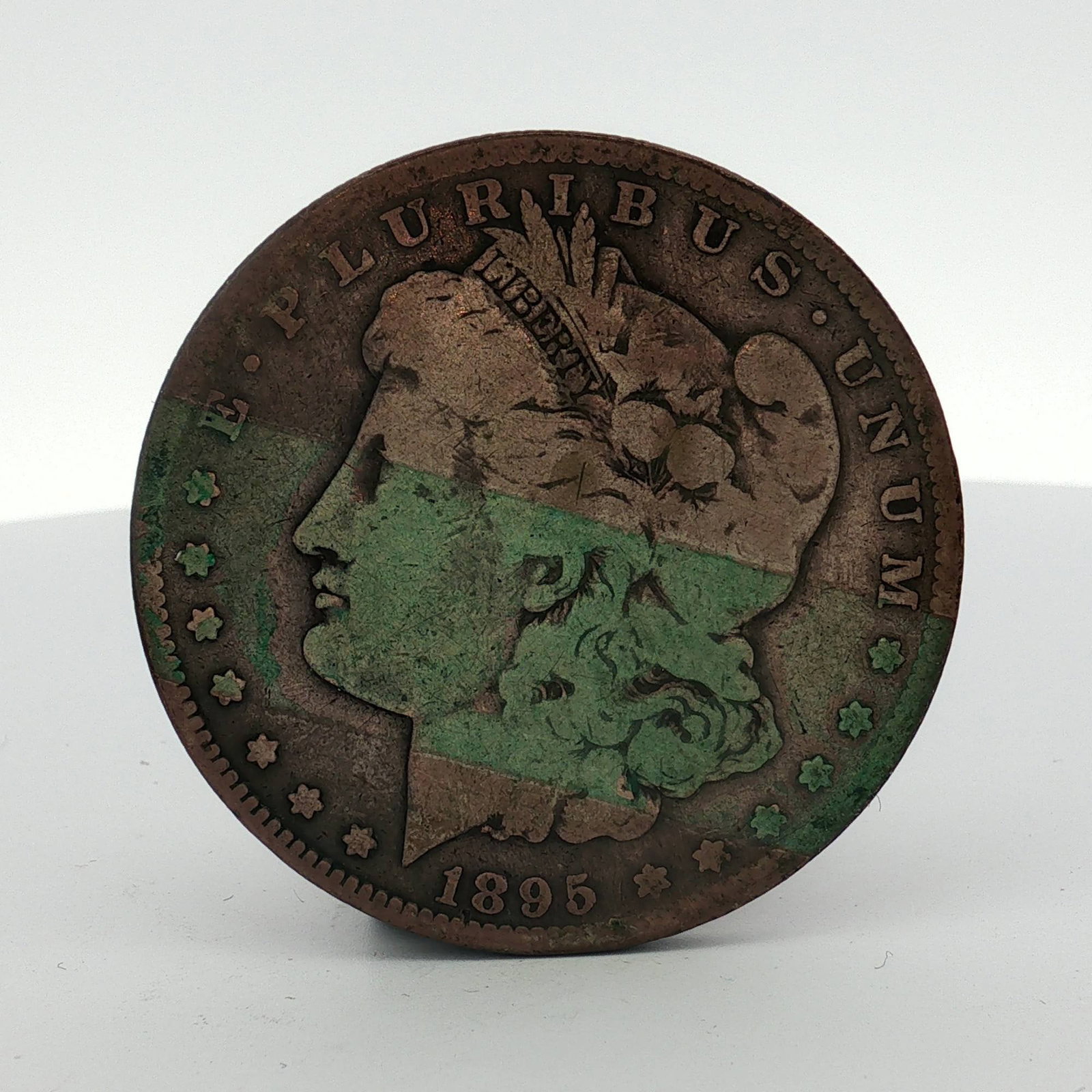 1895 US Morgan Dollar: US 1895 Morgan dollar, KM# 110. This Philadelphia mint issue features the Liberty head obverse and Eagle reverse. The coin is struck with a San Francisco mint mark above the denomination. Weight: 0.85