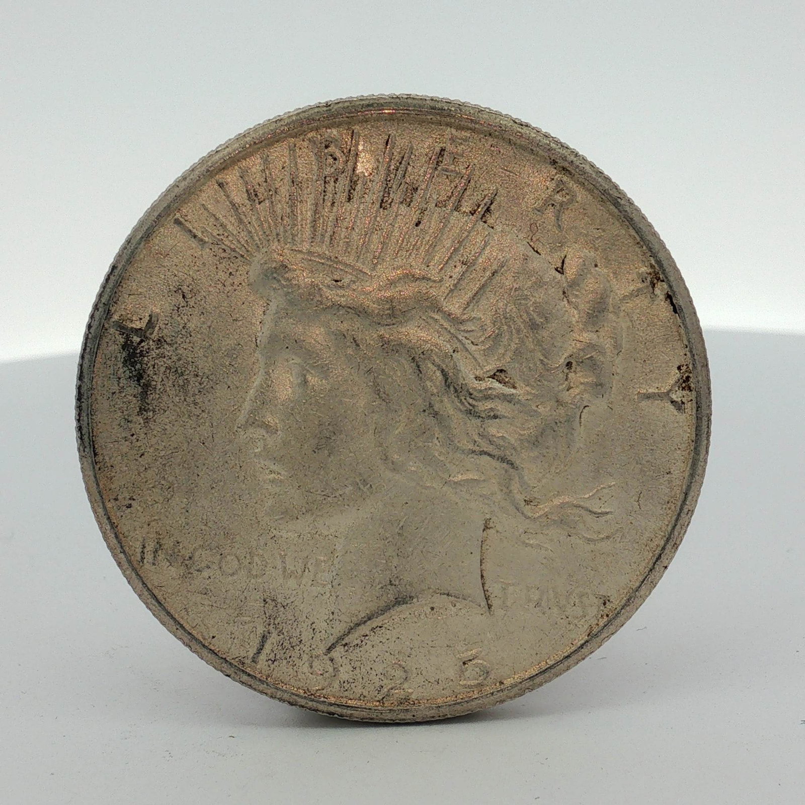 1925-S US Peace Silver Dollar: US 1923-S Peace silver dollar. This specimen is struck in 90% silver and 10% copper with a .900 fineness. The obverse features the Peace dollar design with inscriptions LIBERTY, IN GOD WE TRVST, and t