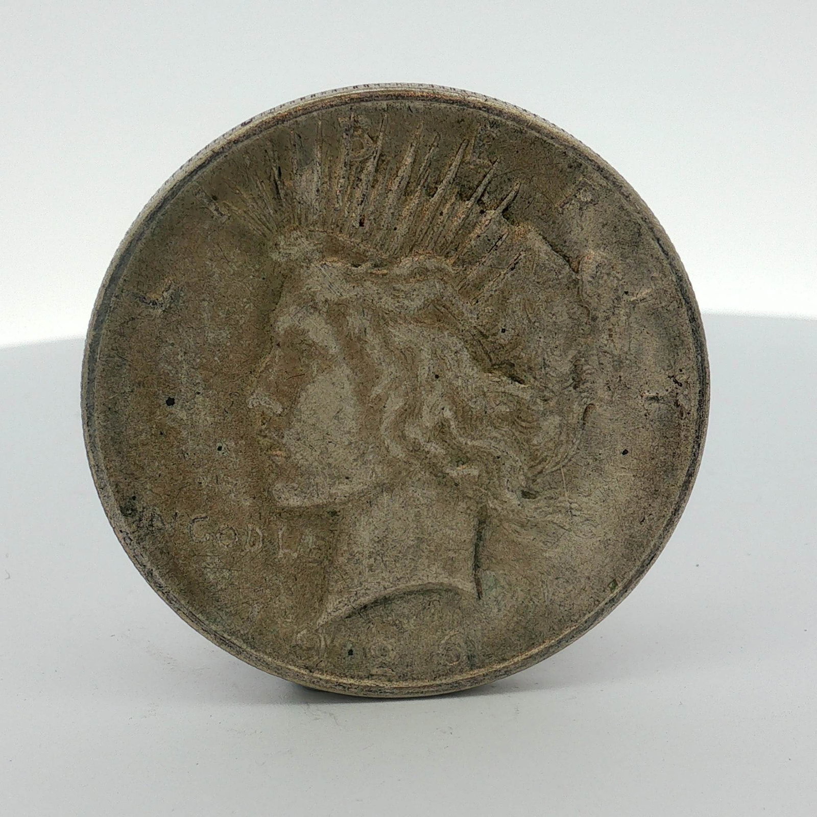 1926-D US One Dollar Peace Silver Dollar, Circulated: This US Peace silver dollar was struck in 0.900 fine silver at the Denver Mint. The obverse features the Liberty head design with a radiate crown. Inscriptions include LIBERTY and IN GOD WE TRUST. The
