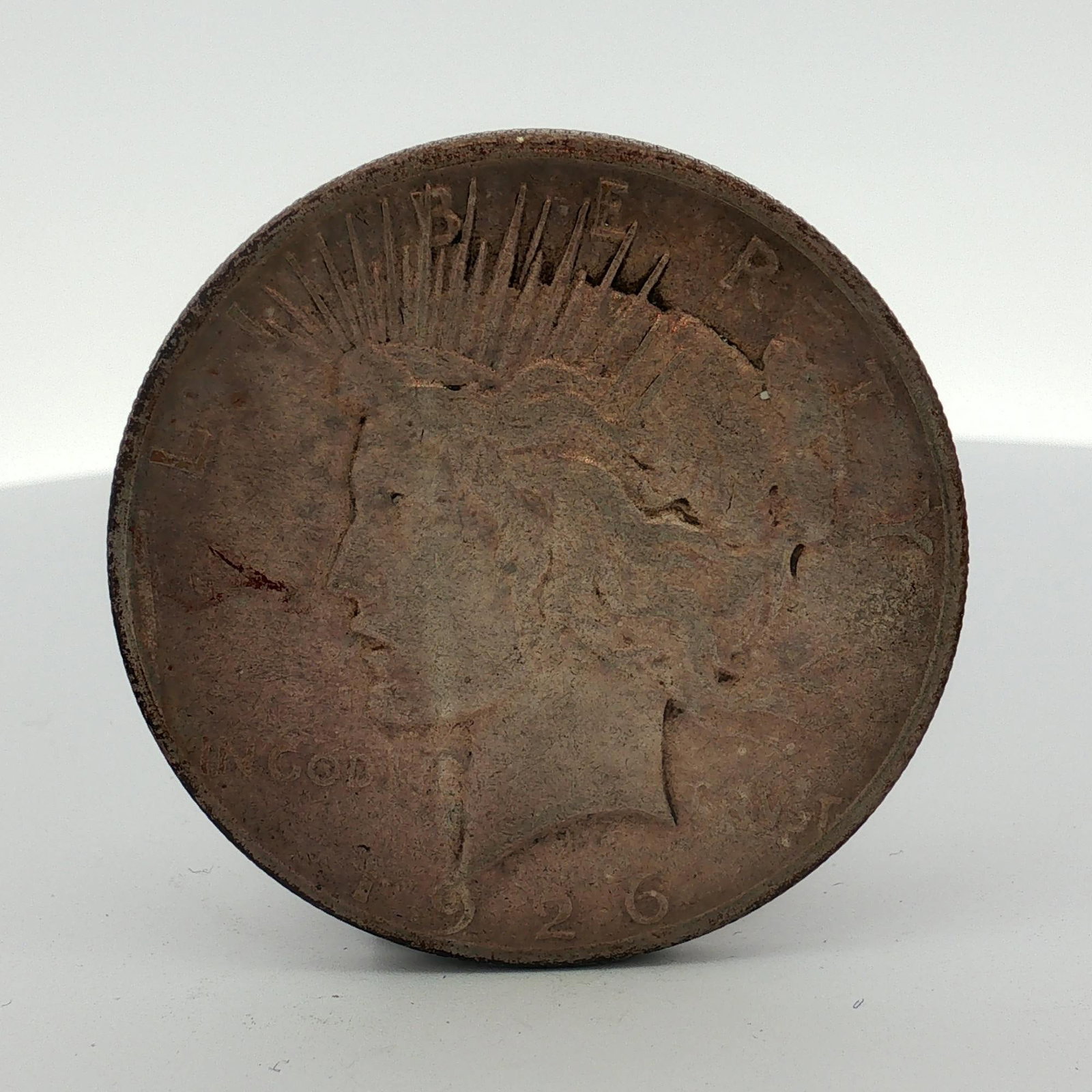 1926-S US Peace Silver Dollar: This 1926-S US Peace silver dollar was struck at the San Francisco mint. The coin features the Peace dollar obverse and reverse designs. Struck in 90 percent silver and 10 percent copper, the specimen