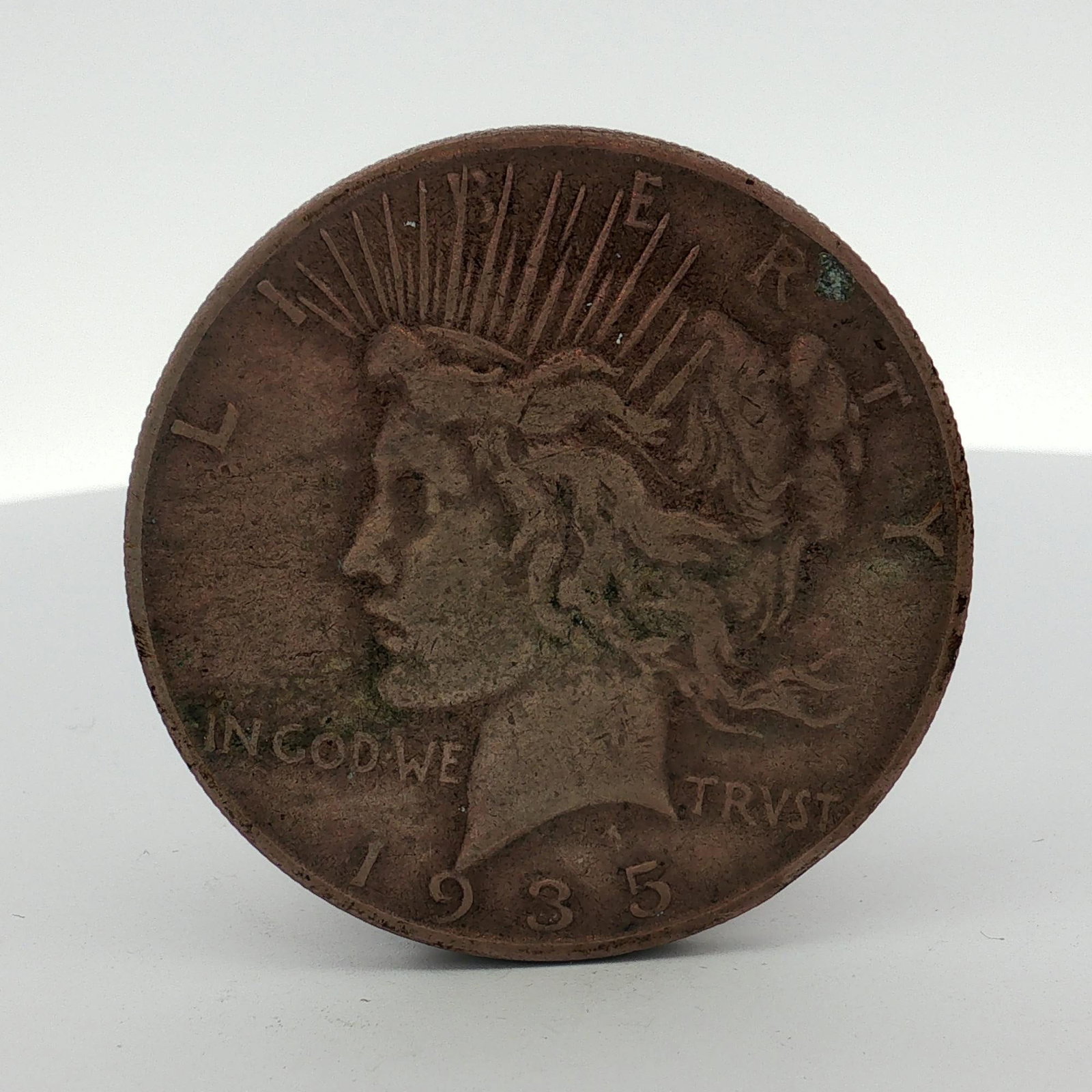 1935-S US Peace Silver Dollar: US 1935-S Peace silver dollar struck at the San Francisco Mint. This Peace dollar is composed of 90 percent silver and 10 percent copper. The obverse features the standard Peace dollar design with the