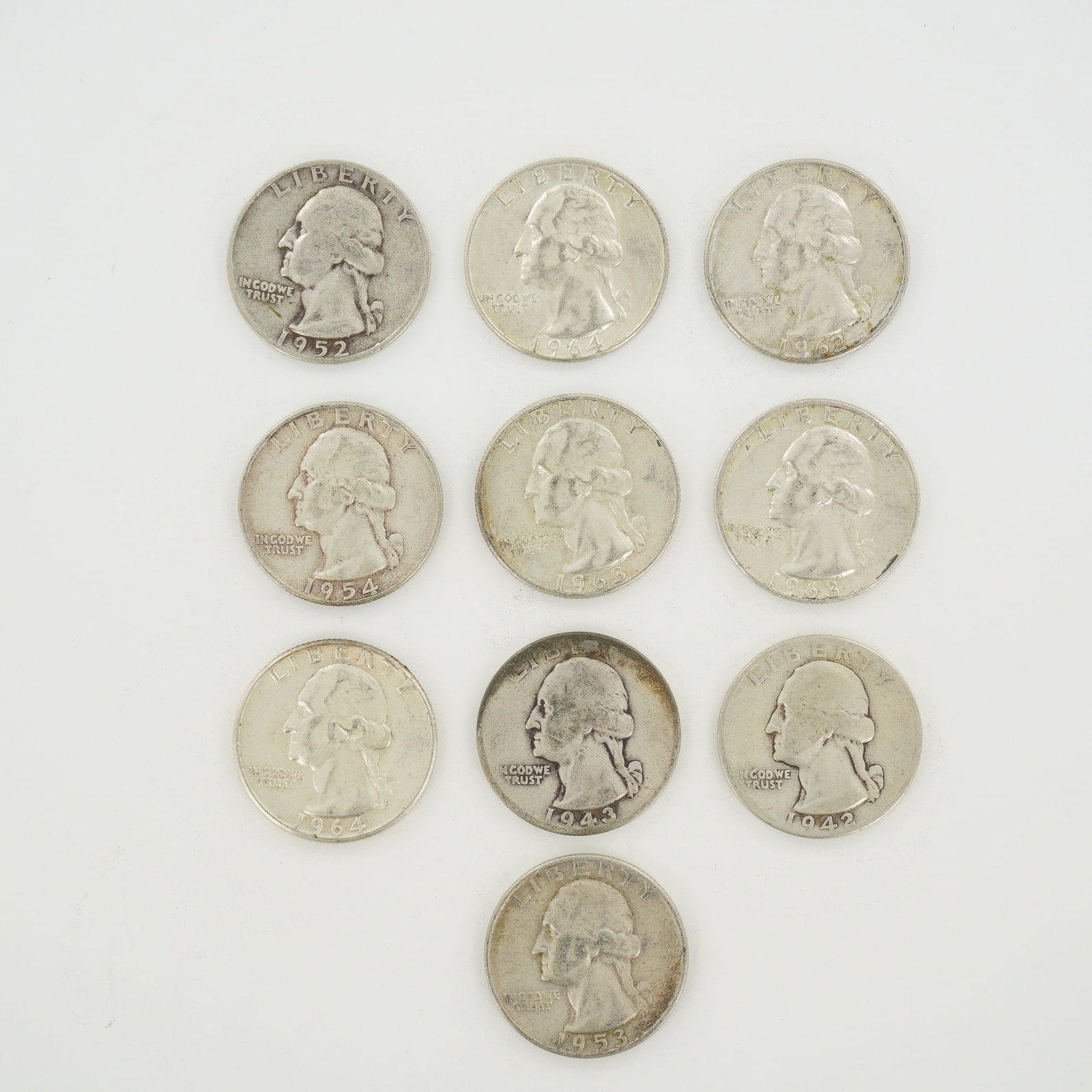 10pc Collection of US Washington Silver Quarters, 1942-1964: A collection of United States Washington quarter dollars minted in 90% silver and 10% copper. This mixed date bag of coinage includes specimens from various years including 1942, 1943, 1952, 1953, 195