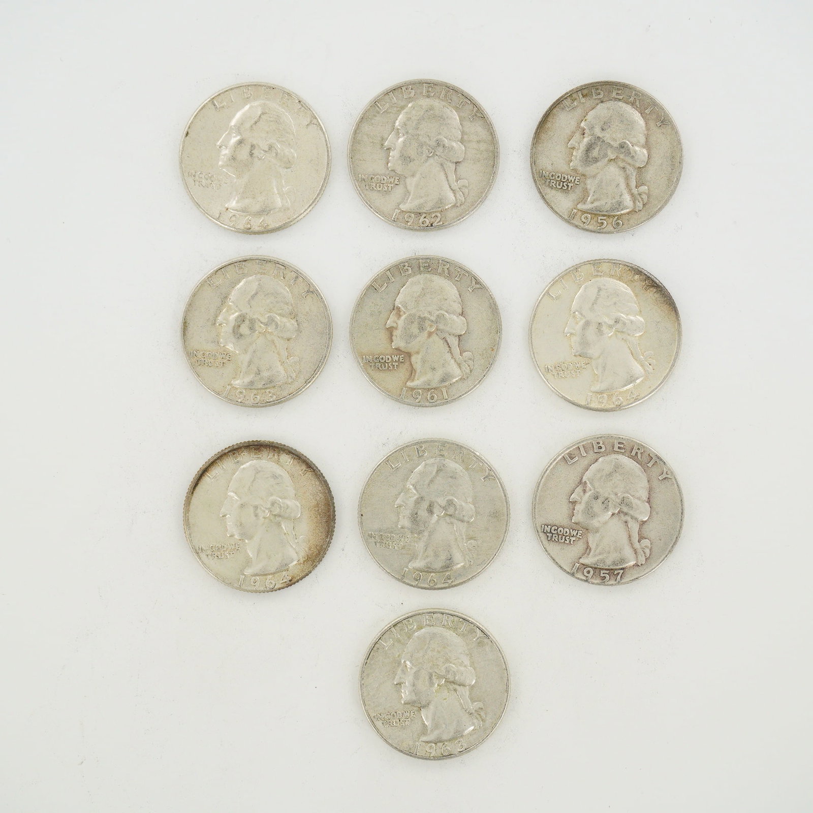 10pc Group of US Silver Washington Quarters, 1956-1964: A group of US Washington Quarters composed of 90% silver and 10% copper. This mixed date bag of coinage includes various years of issue including 1956, 1957, 1961, 1962, 1963, and 1964. The obverse fe