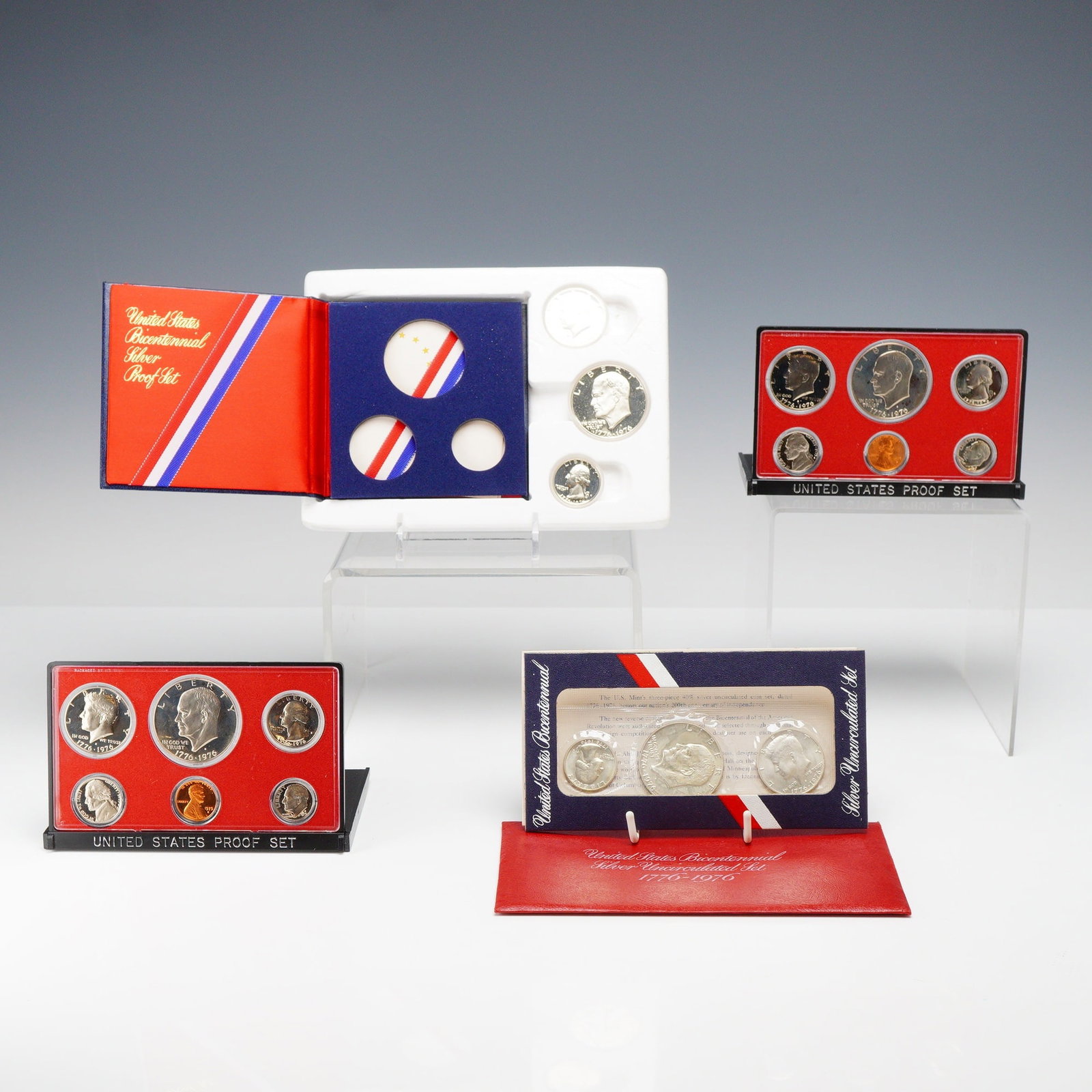 A Lot of 4 US Bicentennial Proof and Silver Uncirculated Coin Sets: This lot of 4 United States proof coin sets and uncirculated strikes includes a variety of issues commemorating the American Bicentennial. The group consists of two 1976 US Proof Sets, each containing