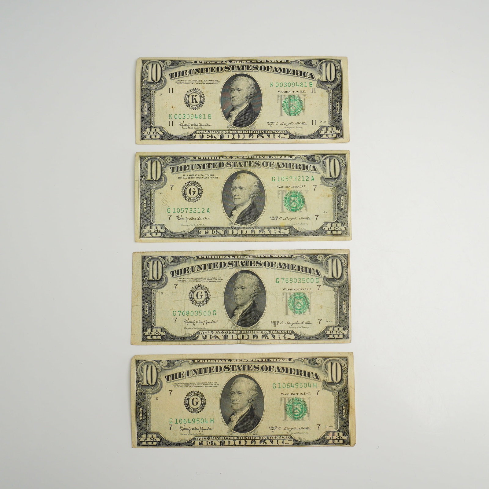 A Collection of US $10 Federal Reserve Notes Series 1950 D and 1963: This collection of vintage US currency $10.00 consists of multiple Federal Reserve Notes from Series 1950 D and Series 1963. The notes feature the central portrait of Alexander Hamilton on the obverse