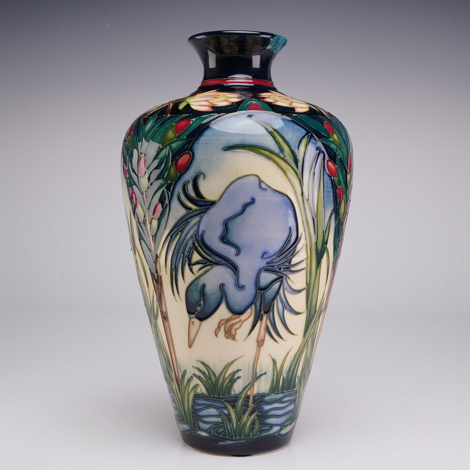 Moorcroft Pottery by Rachel Bishop Vase, Hermanus: The decoration is applied using the traditional tube-lining technique, depicting herons within a marsh landscape of tall green grasses and stylized foliage with red berries. The design is set against 