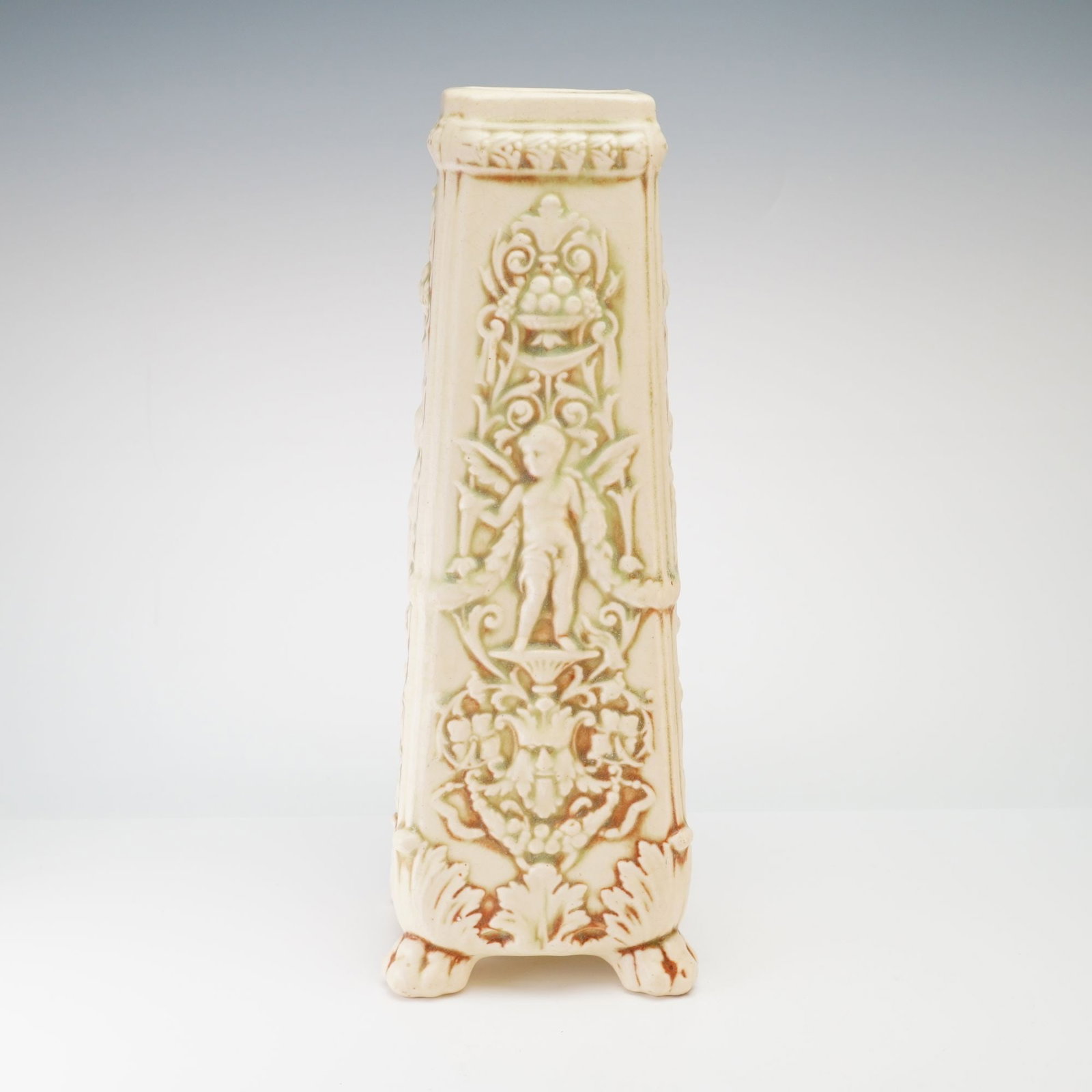 Weller Pottery Renaissance Revival Style Vase, Clinton Ivory: A Weller Pottery glazed earthenware vase in the Clinton Ivory pattern. This piece is designed in the Renaissance Revival style, featuring a tall, tapering square-section form with a slightly flared