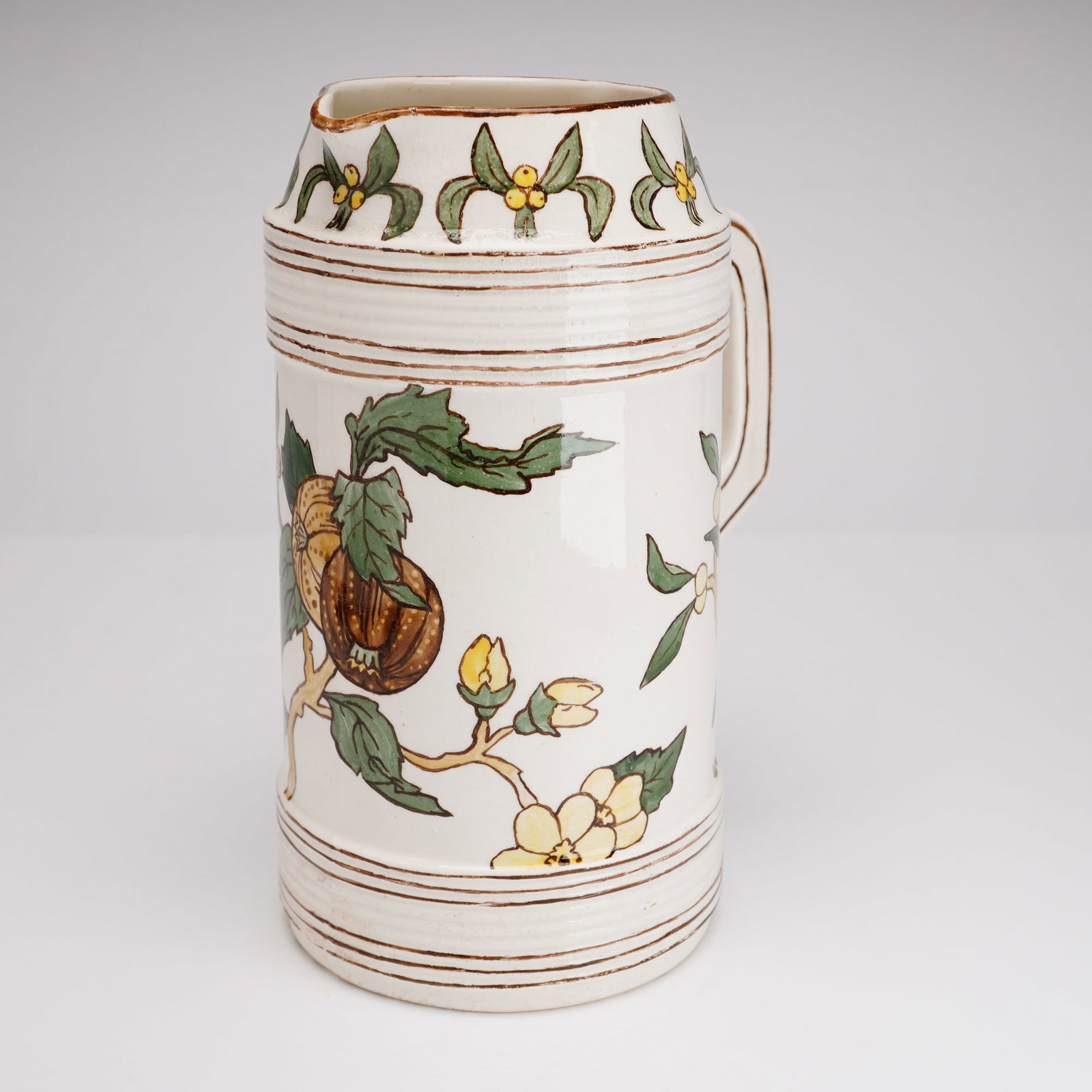 Victorian Hand-Painted Ceramic Pitcher by Mary Vinton, dated 1876: This Victorian-era ceramic pitcher, dated 1876, is a fine example of the personalized hand-painted earthenware popular during the late 19th-century Aesthetic Movement. The vessel features a cylindrica
