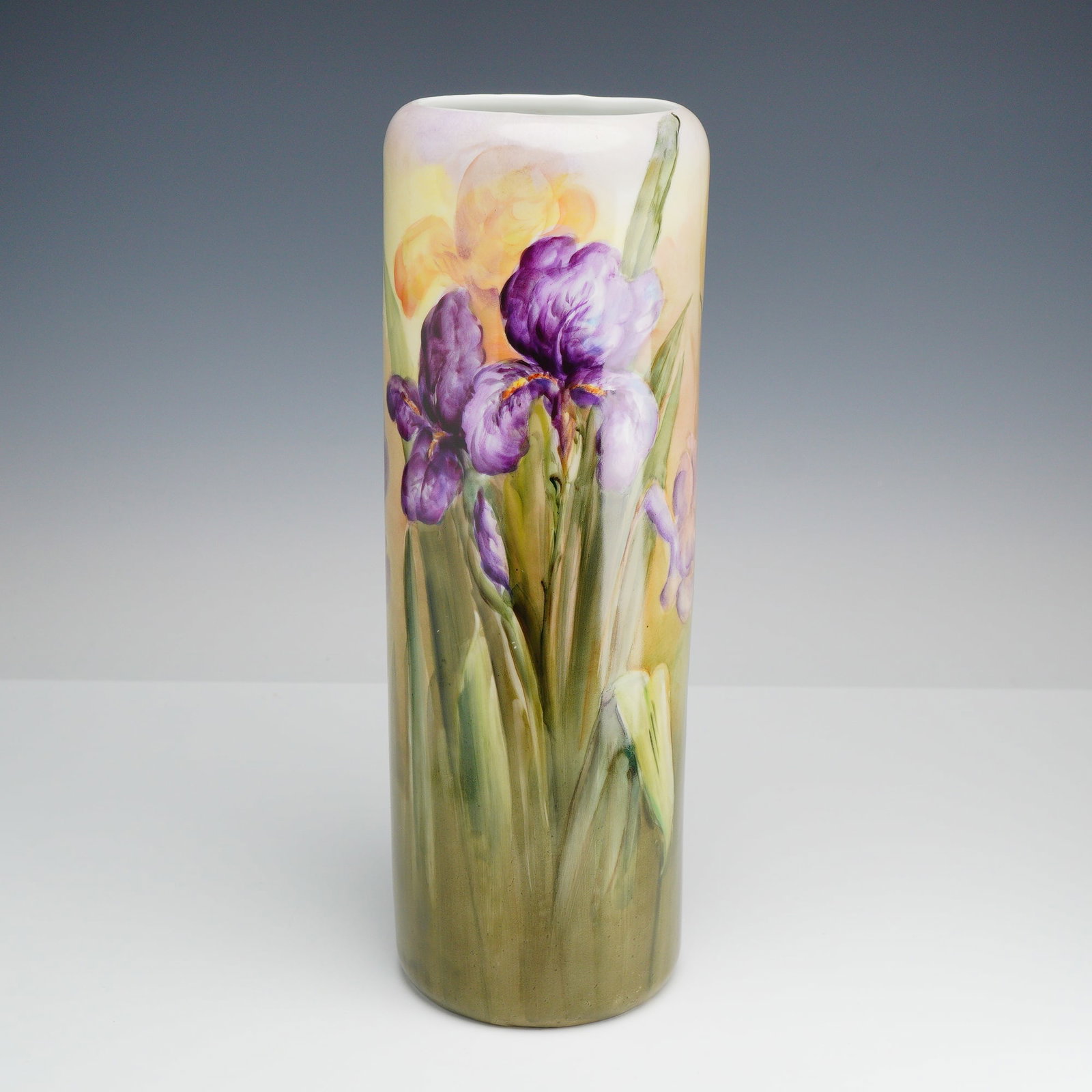 Austrian Hand-Painted Porcelain Sleeve Vase with Purple Iris Flowers: This tall cylindrical porcelain sleeve vase, in the style of Vienna, Austria, features hand-painted floral decoration. The exterior is decorated with a continuous scene of purple and yellow irises wit