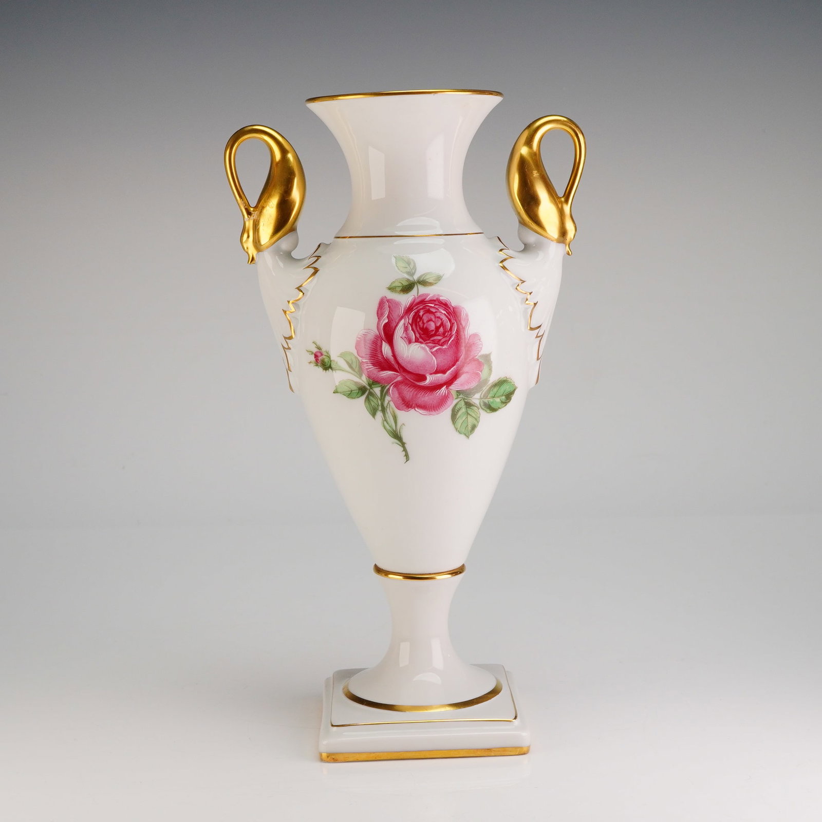 Alboth & Kaiser Porcelain Vase with Double Swan Handles, Moss Rose: The white glazed amphora-form body is supported by a tapering pedestal resting on a square foot, all extensively gold gilded. The vase features double handles in a distinctive swan motif, fully finish