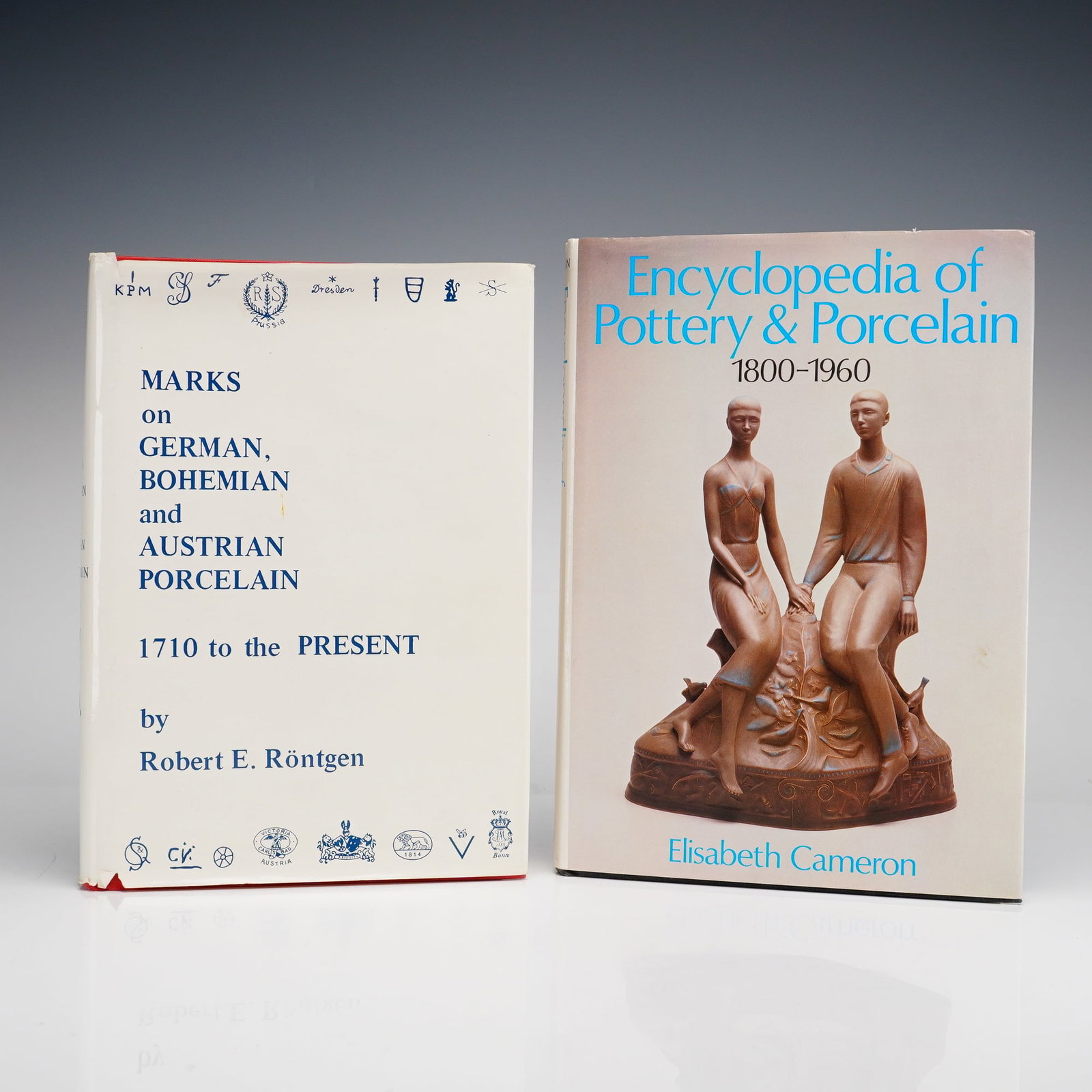 2pc Porcelain and Pottery Hardcover Reference Books: This lot consists of two hardcover reference books focusing on ceramic history and identification. The first volume is Marks on German, Bohemian and Austrian Porcelain: 1710 to the Present by Robert E