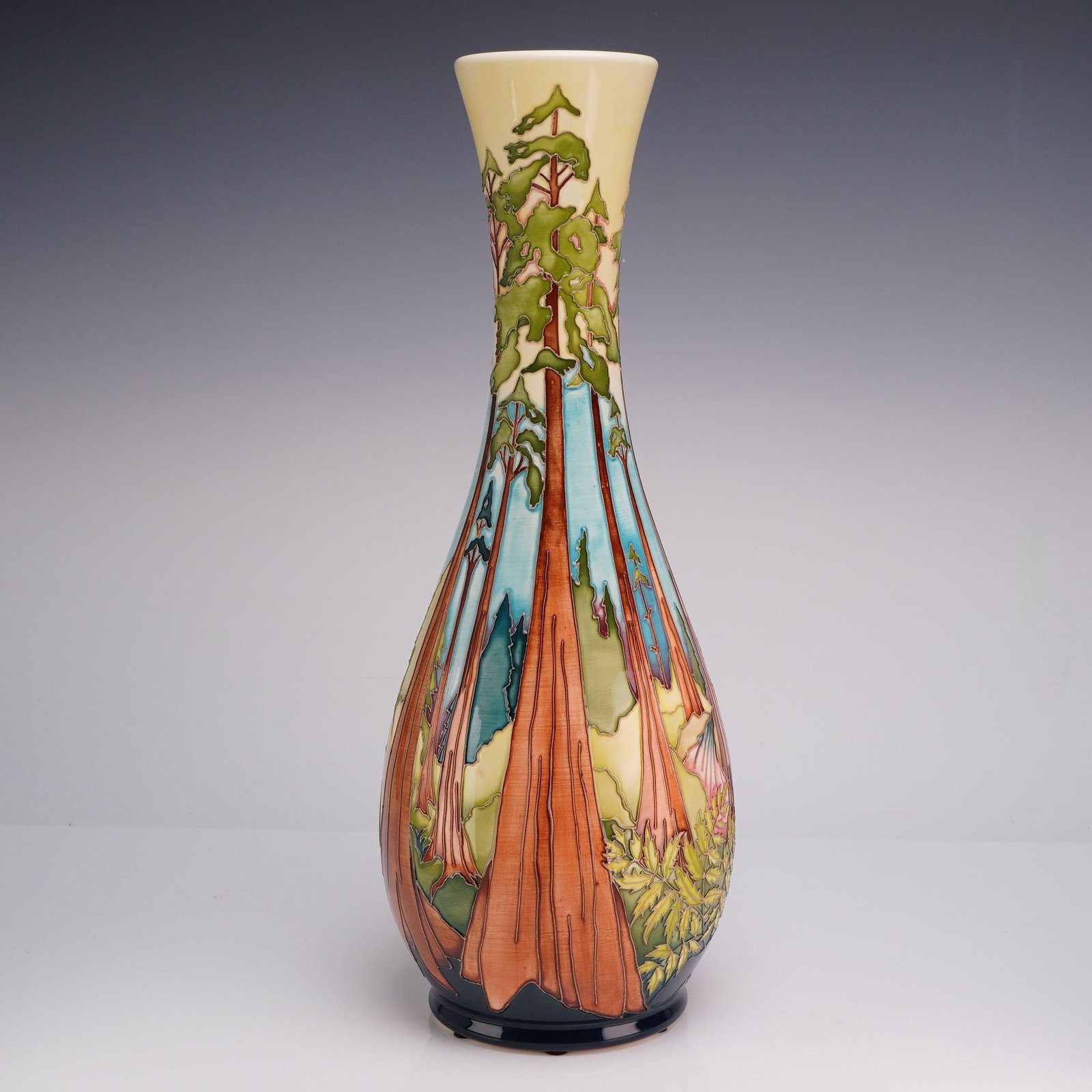 Moorcroft Pottery Hayley Moore Design Trial Redwoods Pattern Bottle Vase 2023: A tall earthenware bottle vase characterized by a long, slender neck that flares slightly at the rim and a bulbous lower body. The piece is decorated using the tube-lining technique, depicting a conti