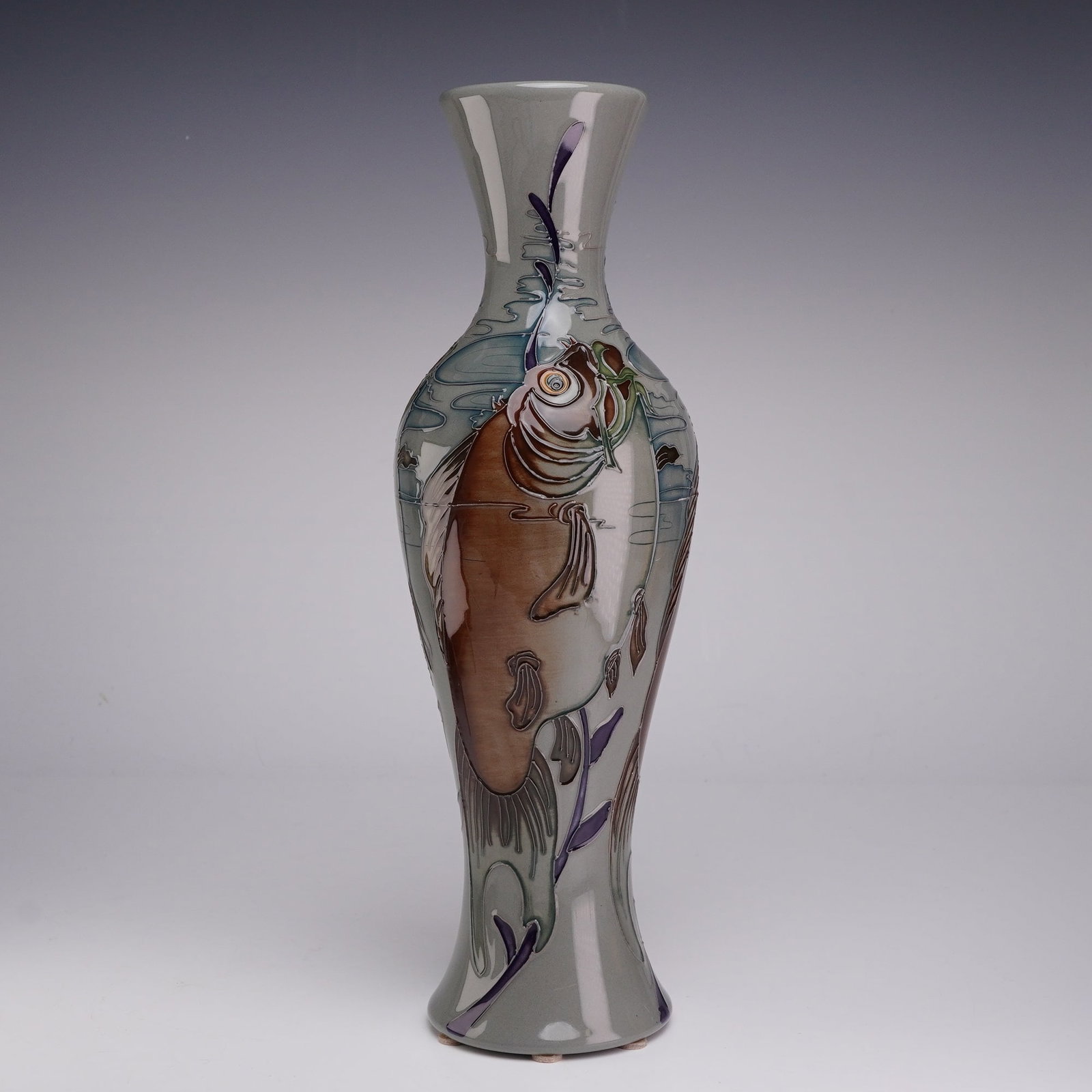 Moorcroft Pottery by Kerry Goodwin Limited Edition Vase, Tail Dance: This lot features a tall, slender art pottery vase manufactured by Moorcroft in the Tail Dance pattern, designed by Kerry Goodwin. The piece is constructed of glazed earthenware with a flared rim, elo