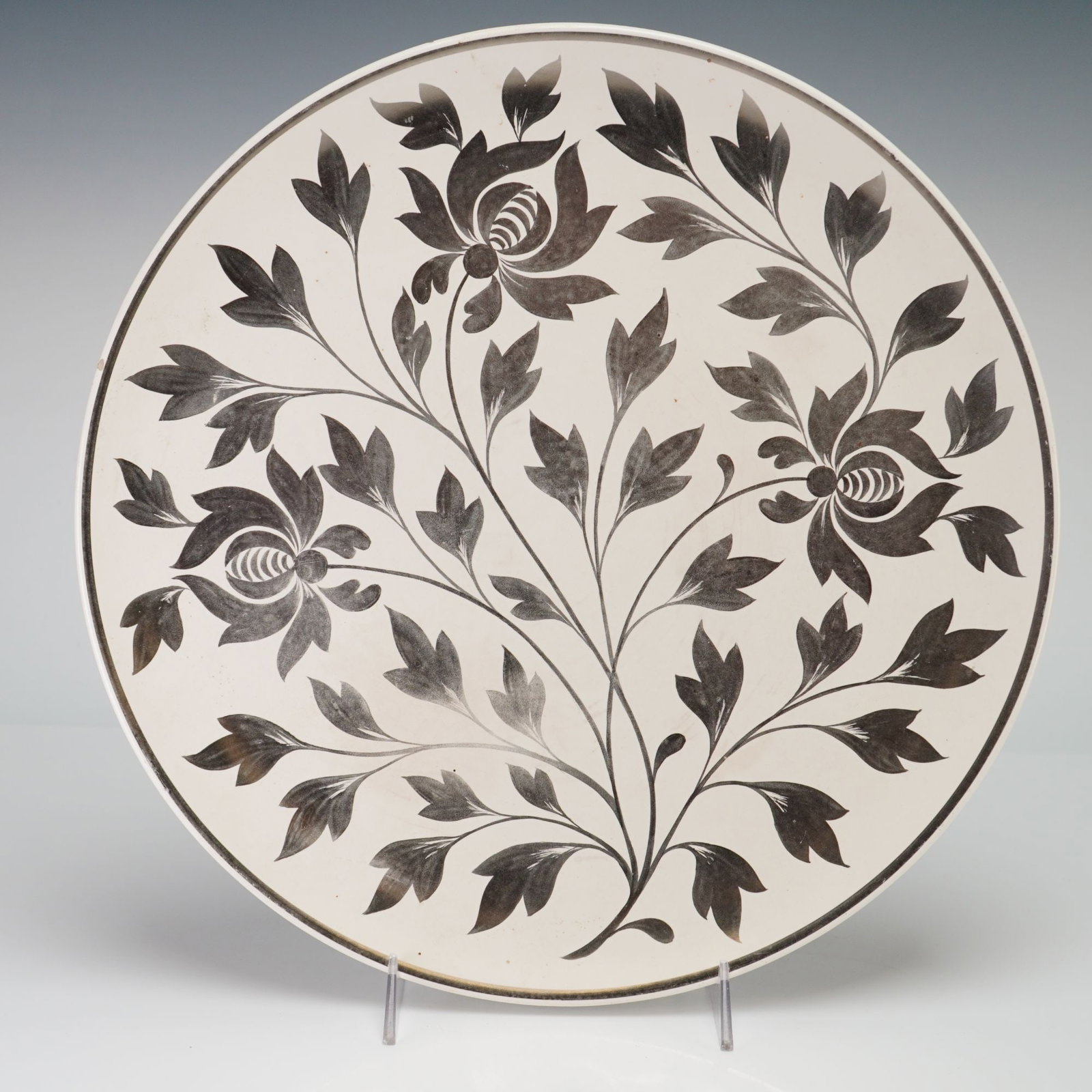 Wedgwood Etruria Hand Painted Floral Creamware Platter: This Wedgwood creamware platter, also referred to as a charger, was produced at the Etruria factory in England. The piece is constructed from cream-colored earthenware, often called Queen's Ware, and 