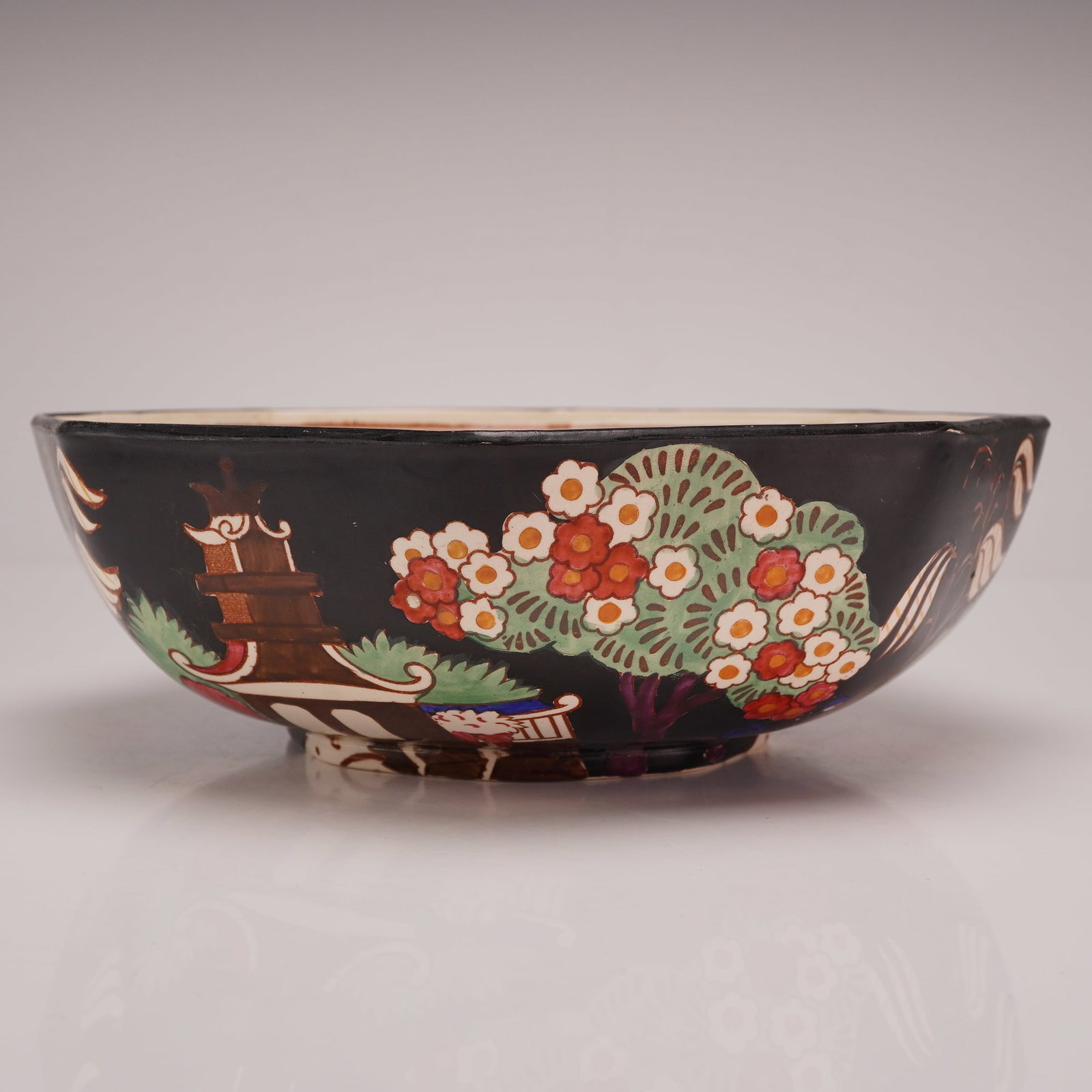 Wedgwood Octagonal Chinoiserie Black Ground Bowl from the Rubin Collection: This octagonal earthenware bowl was produced by Wedgwood at the Etruria works in England. The exterior features a matte black ground decorated with Chinoiserie motifs, including pagodas and flowering 