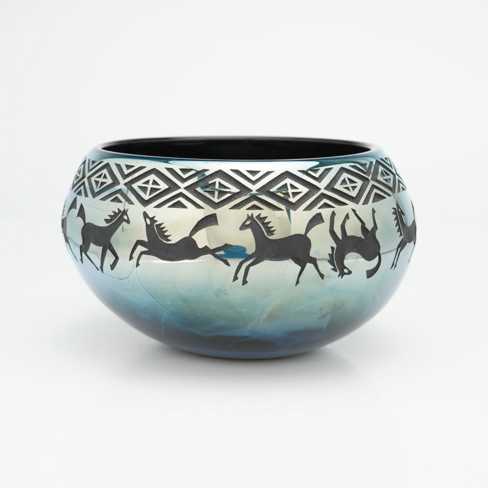 William Walker Iridescent Art Glass Cameo Bowl: This iridescent art glass bowl is a work by artist William Walker, identified by the ww marking and associated with the Rubin Collection. The vessel, also referred to as a vase, features a squat, bulb