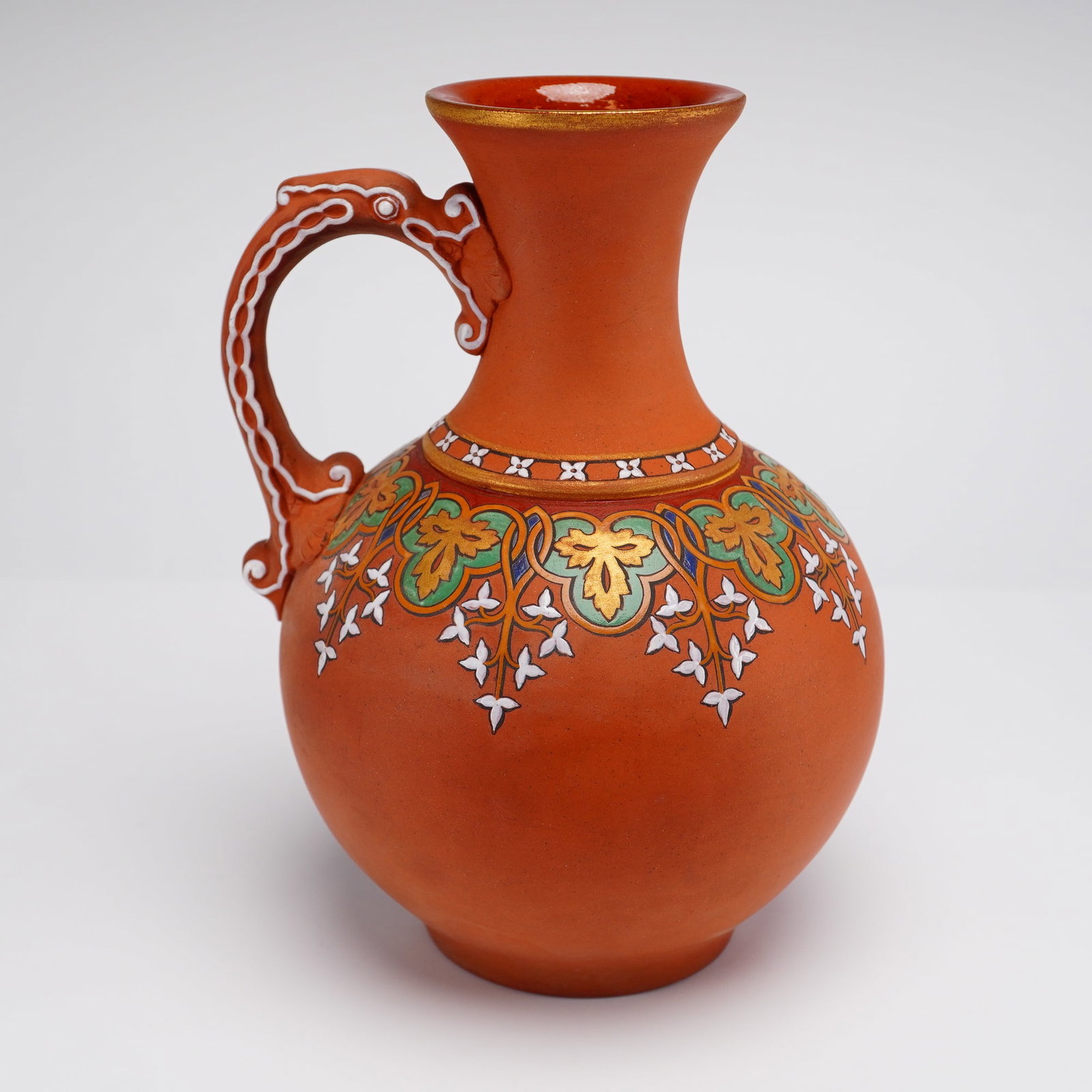 S. Alcock and Co. Enameled Terracotta Ewer: A mid-19th-century English terracotta jug produced by Samuel Alcock and Co. of Burslem, Staffordshire. Part of the Rubin Collection, this vessel is constructed from matte, unglazed red-orange earthenw