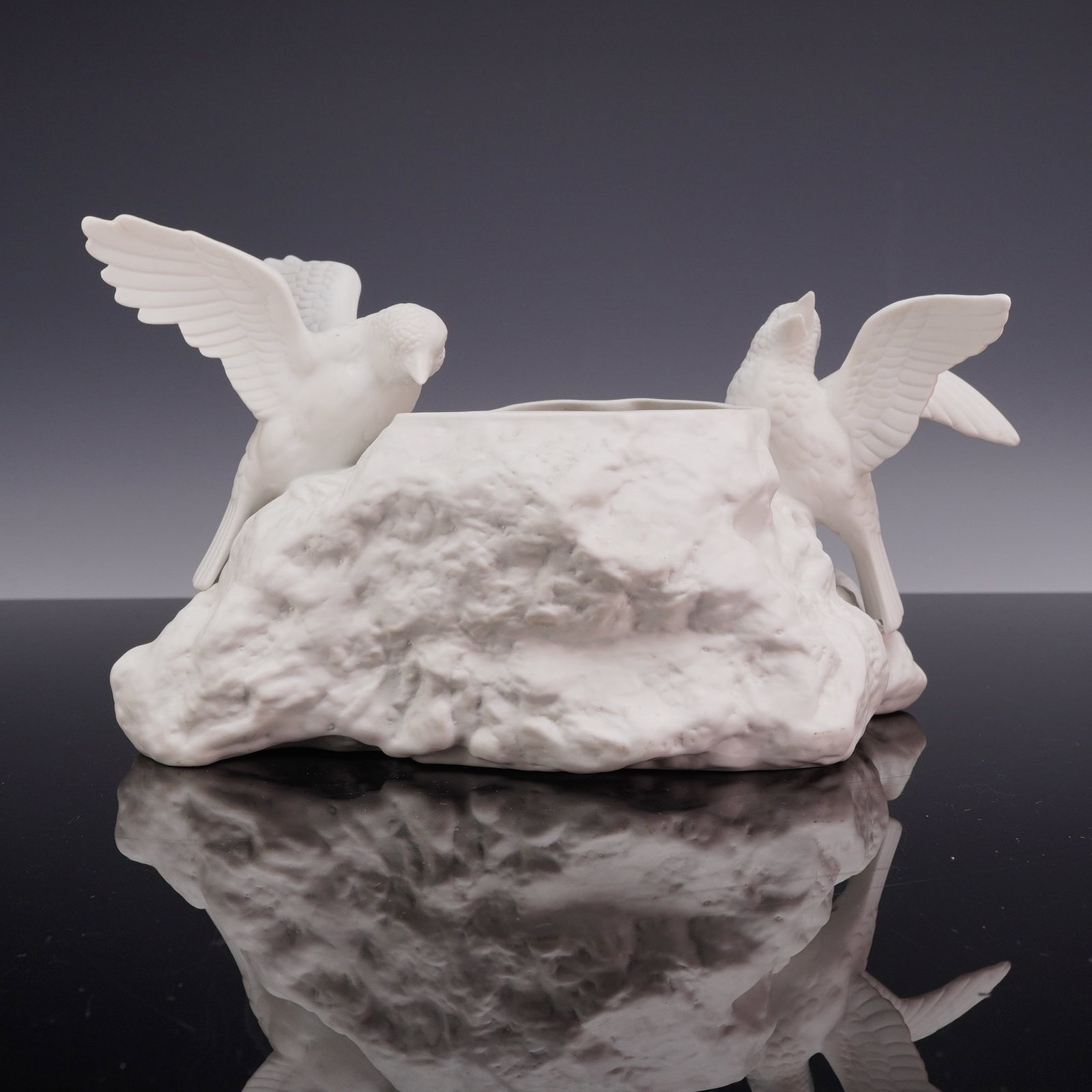 Vintage White Bisque Porcelain Bird Motif Planter: A vintage white bisque porcelain planter featuring two bird figurines perched on a textured rock-form base. The vessel is modeled as a craggy, naturalistic outcropping with a central hollow aperture, 
