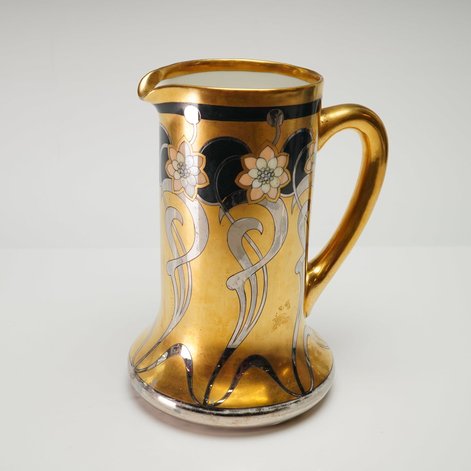 Hand-Painted W.A. Pickard China Pitcher: This hand-painted porcelain pitcher was produced by Pickard Studios of Chicago, Illinois, in the early 20th century. The vessel features a tapered cylindrical body with a flared base and a prominent g