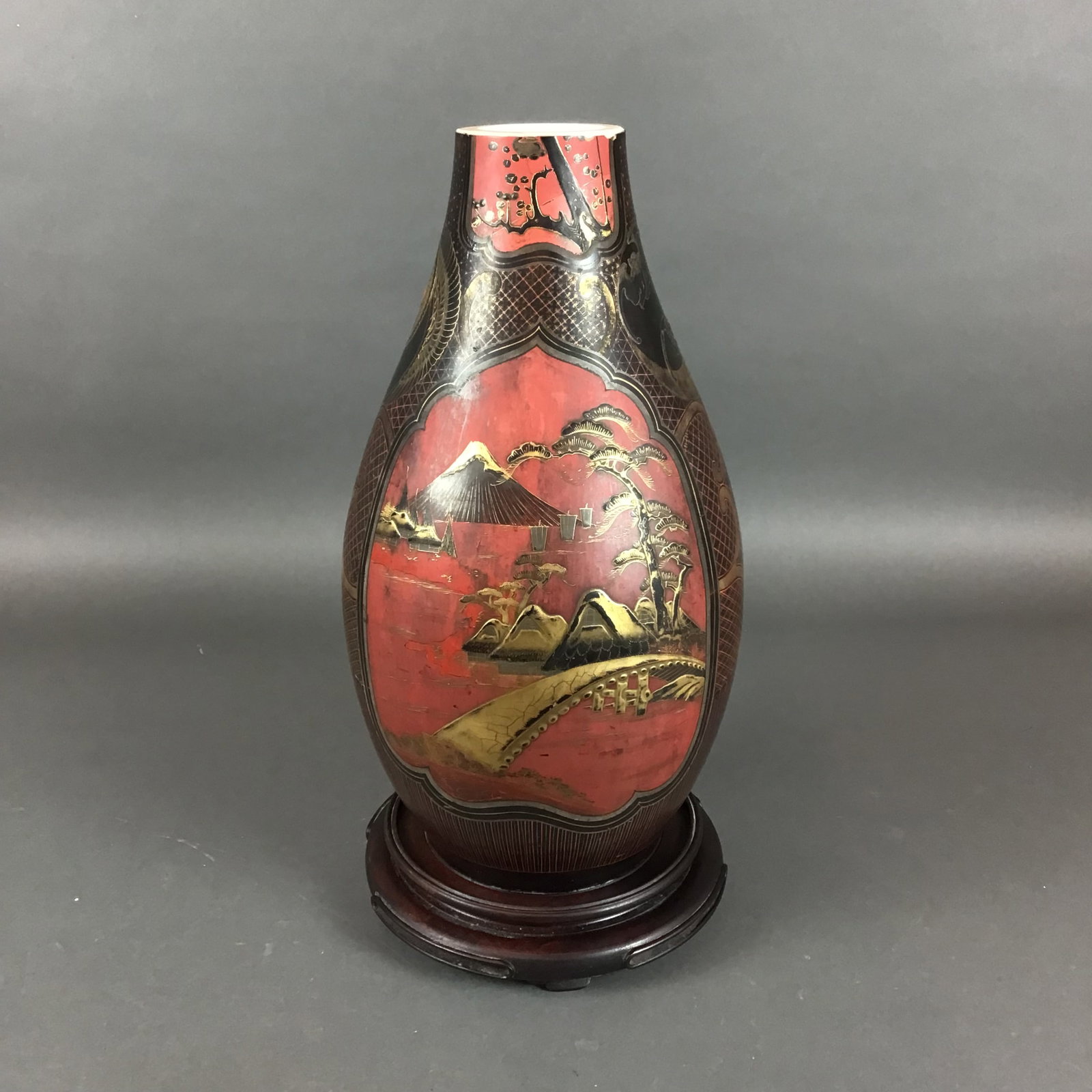 Japanese Meiji Period Jitai Shippo Lacquer on Porcelain Vase with Stand: This ovoid porcelain vase is executed in the jitai shippo technique, featuring a lacquer finish applied over a porcelain body. The exterior is decorated with a black and red lacquer ground, embellishe