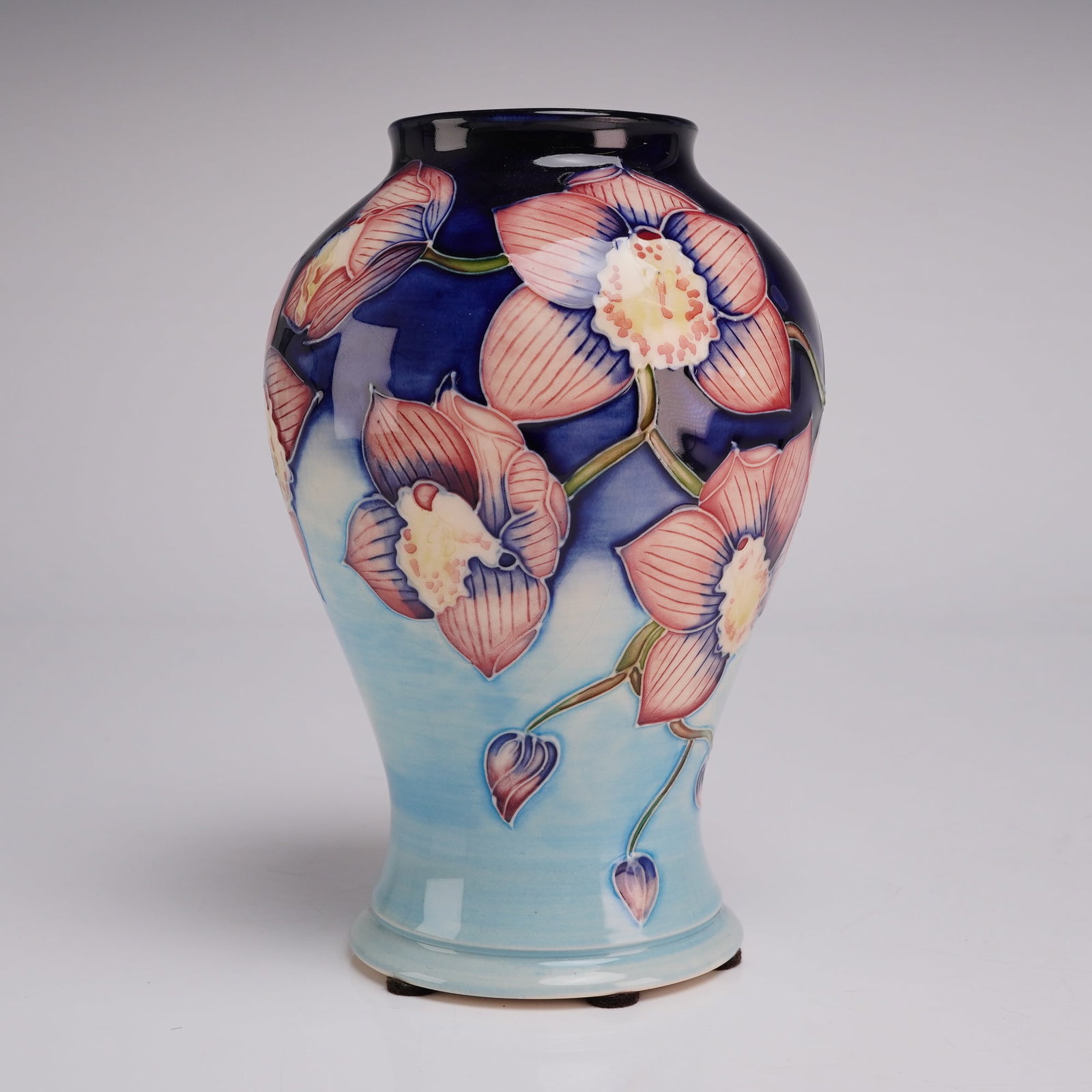 Moorcroft Pottery Anji Davenport Limited Edition Orchid Pattern Baluster Vase Signed and Dated 2001: A limited edition tube-lined earthenware vase by Moorcroft Pottery of Stoke-on-Trent, England. The baluster-shaped vessel features a flared rim and base. The hand-painted and slip-trailed decoration d