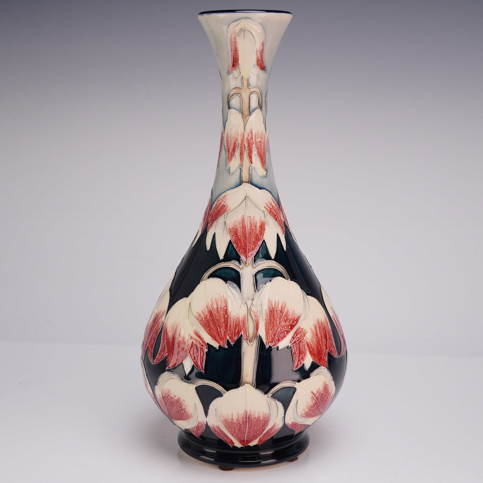 Moorcroft Desert Orchid Limited Edition Vase by Anji Davenport Dated 2003 Numbered 166 of 300: A Moorcroft earthenware pottery vase in the Desert Orchid pattern designed by artist Anji Davenport. The vase features a tall baluster form with a slender, flared neck and a bulbous body tapering to a