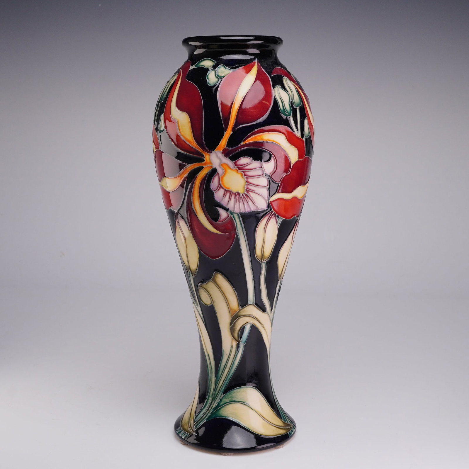 Moorcroft Pottery by Kerry Goodwin Limited Edition Vase, Orchid: A Moorcroft Pottery by Kerry Goodwin produced as a limited edition exclusive for the retailer Pascoe and Company. The vessel features a tall, waisted form with a flared rim and a spreading circular fo
