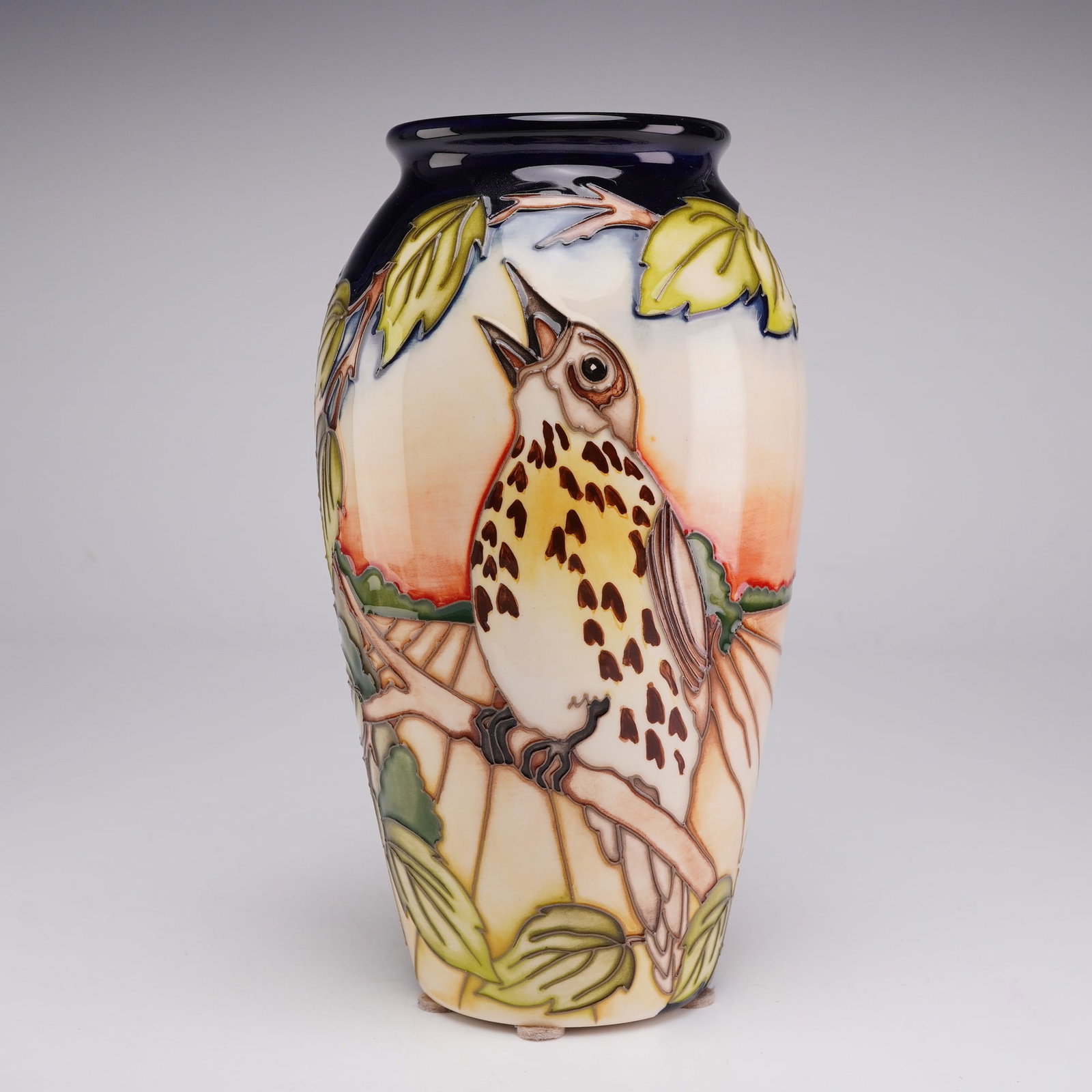 Moorcroft Pottery by Kerry Goodwin Limited Edition Vase, Song Thrush Serenade: This ovoid-form earthenware vase is decorated using the traditional tube-lining technique and hand-painted with underglaze colors. The central motif depicts a song thrush perched on a branch with its 