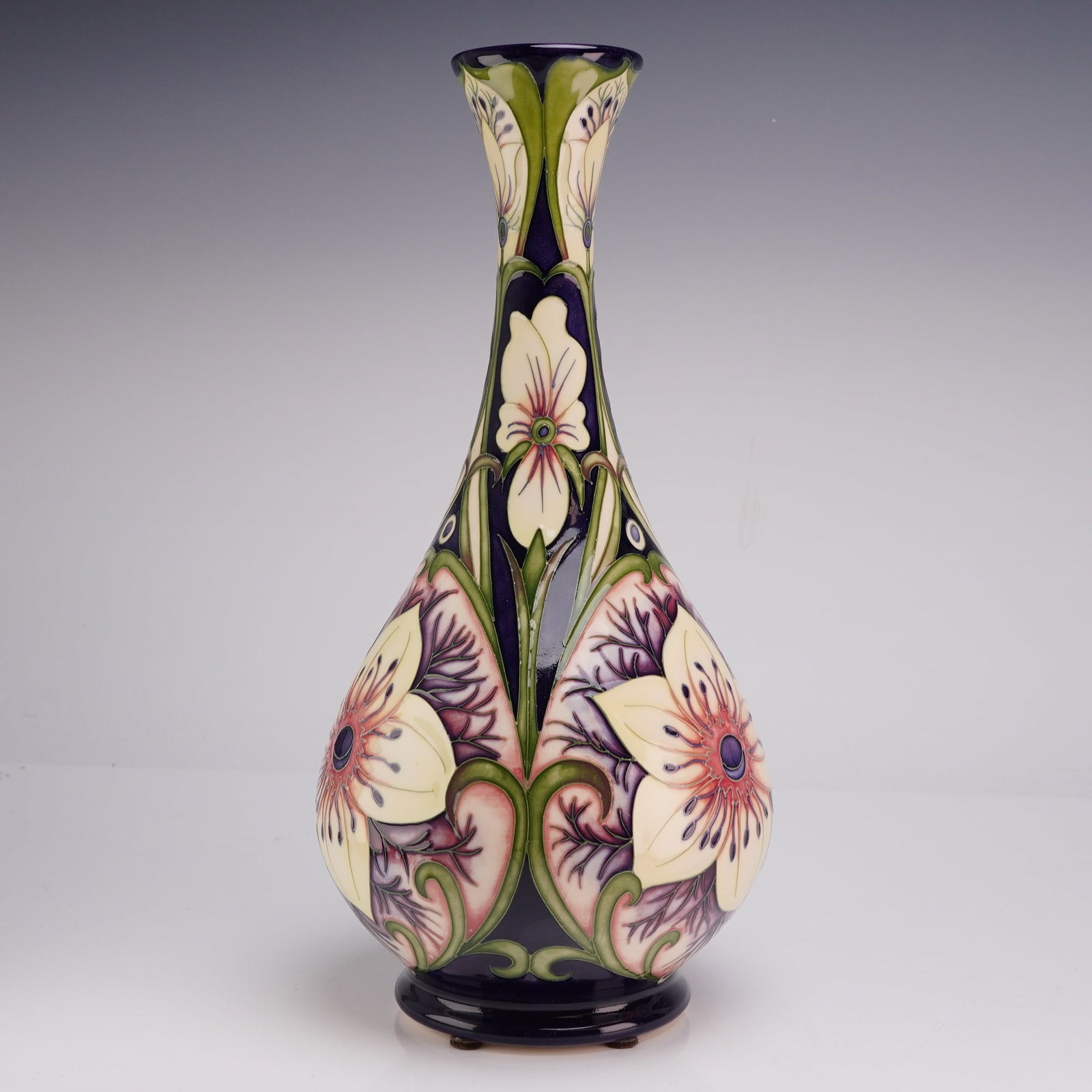 Moorcroft Limited Edition Rachel Bishop Signed African Bride Ceramic Vase Dated 2006: A Moorcroft earthenware art pottery vase featuring a design by senior designer Rachel Bishop. The vase displays a tall, slender neck with a flared rim, a bulbous body, and a raised circular foot. The 