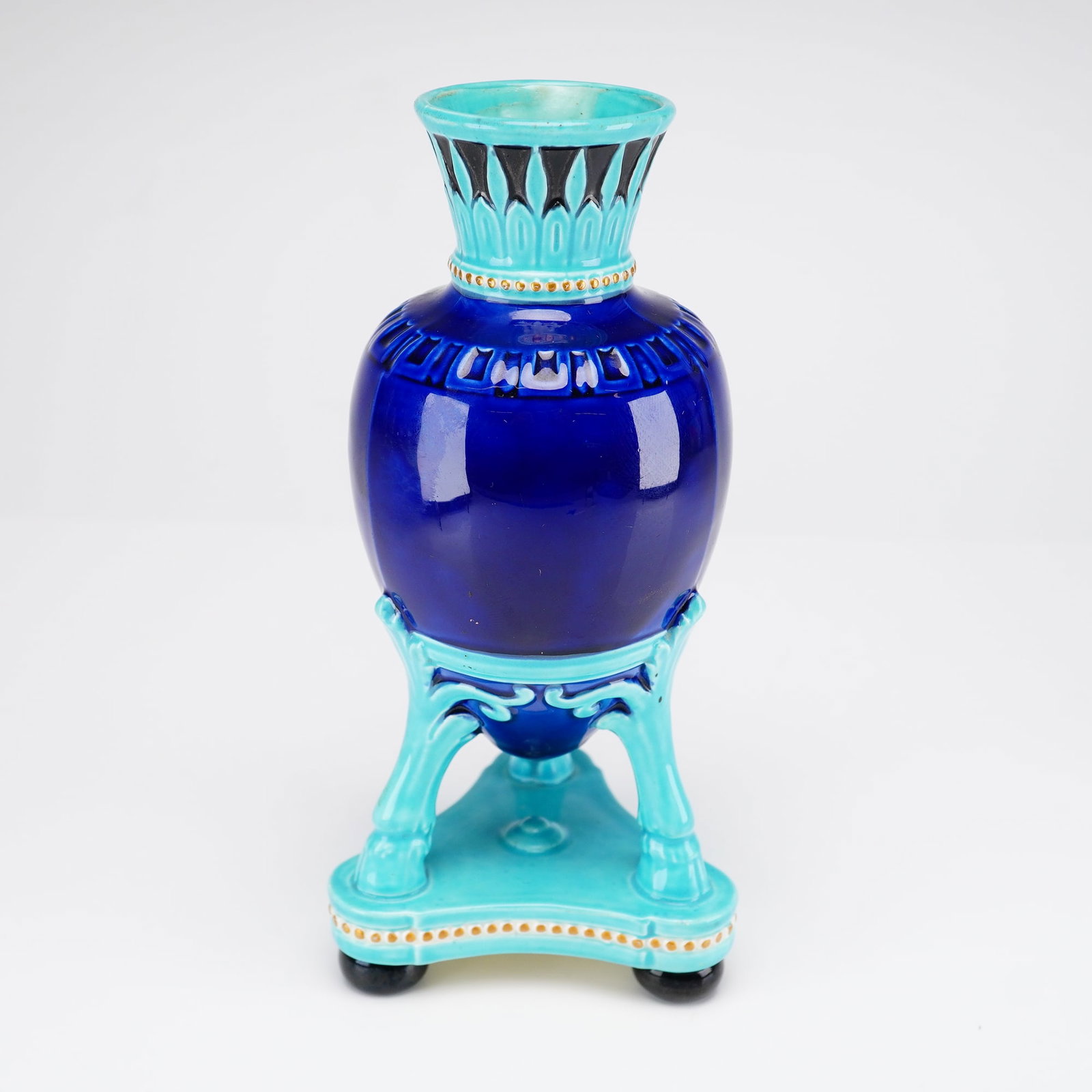Wedgwood Majolica Neoclassical Cobalt Blue Tripod Vase: A Victorian Wedgwood majolica glazed earthenware tripod vase from the Dr. Ellis F. and Suzanne Borow Rubin Collection. The oviform vessel features a deep cobalt blue glaze body and a gadrooned neck de