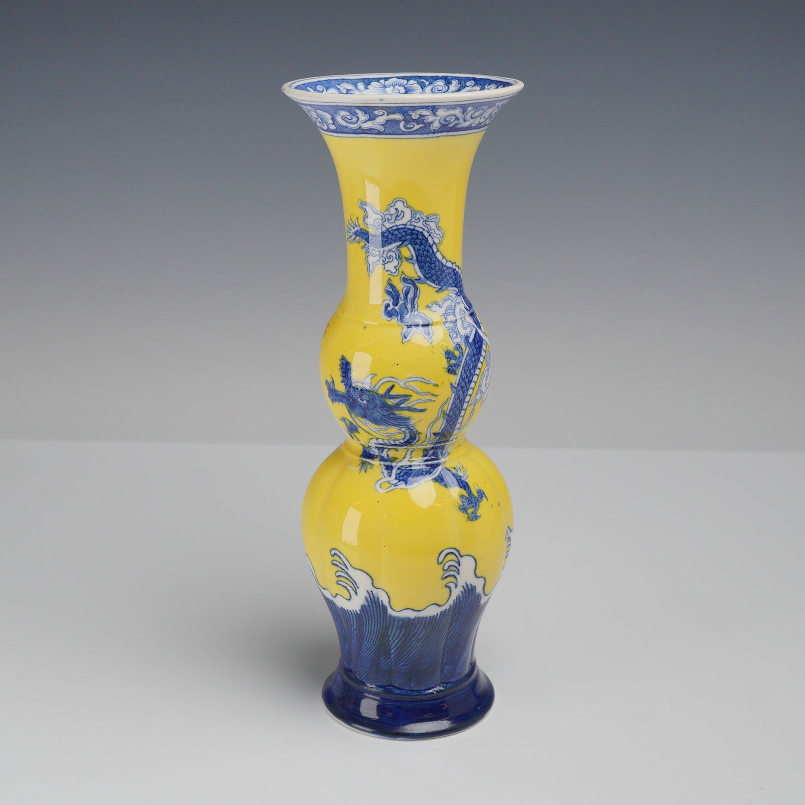 Wedgwood Chinoiserie Dragon Pattern Yellow Ground Triple Bulb Porcelain Vase: This Wedgwood porcelain triple-bulb vase is decorated in the Chinoiserie Dragon pattern, featuring underglaze blue motifs set against a vibrant yellow ground. The central decoration depicts a five-cla