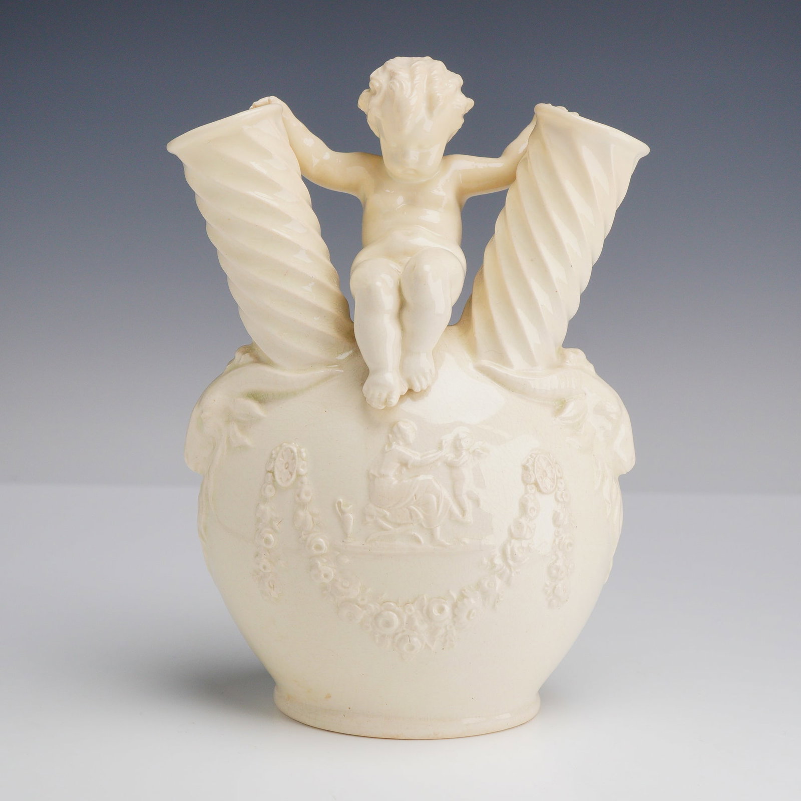 Wedgwood Etruria Queensware Twin Cornucopia Vase: A Wedgwood Queensware creamware decorative twin cornucopia vase, formerly part of the Rubin Collection. The vessel is designed with a central globular body on a circular foot, surmounted by a seated p