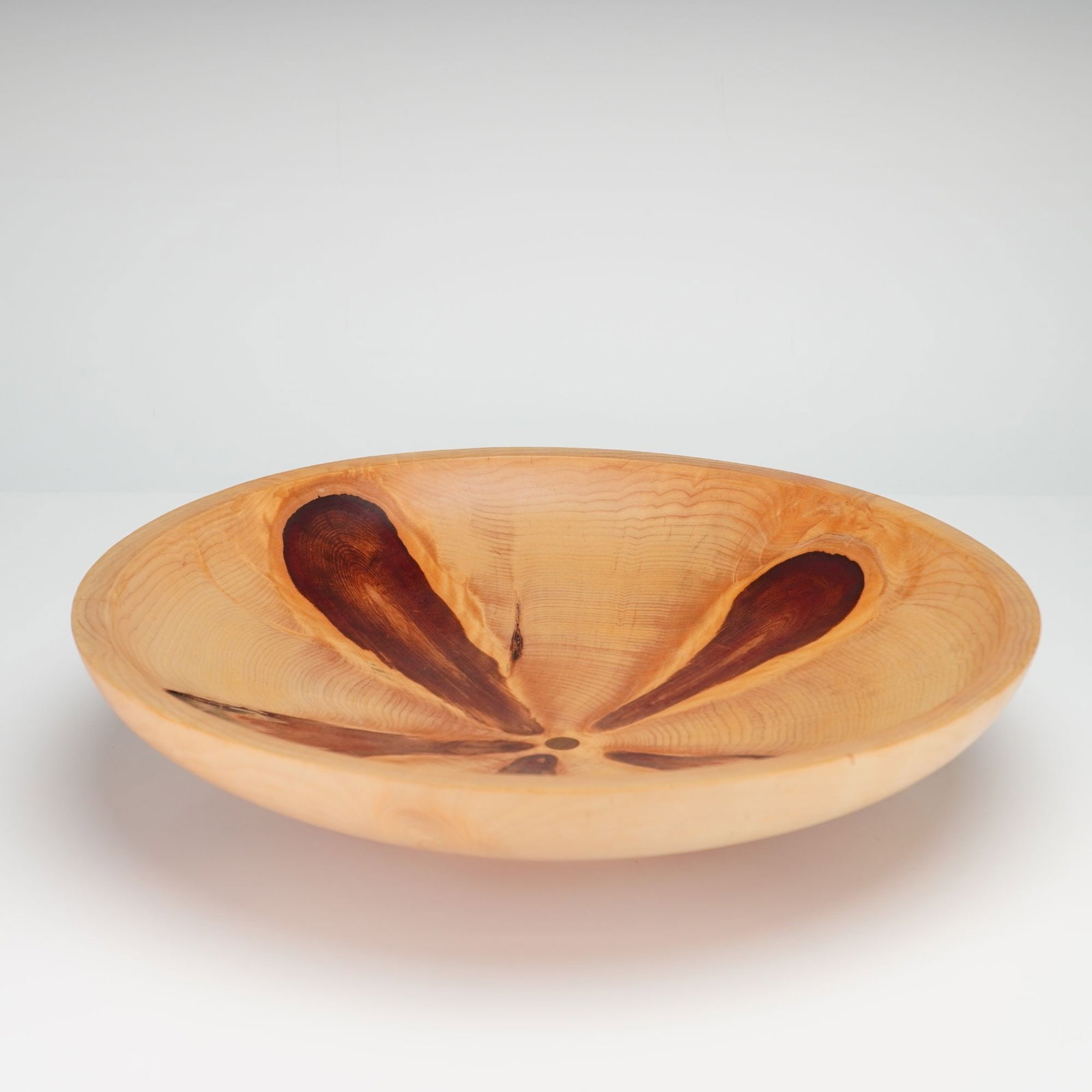 Alan Wedgwood Hand-Turned Monkey Puzzle Wood Bowl, 2005: This hand-turned wooden bowl is crafted from monkey puzzle wood, Araucaria araucana. The vessel features a shallow, wide form with a flared rim. The wood grain exhibits a light-colored ground with a r