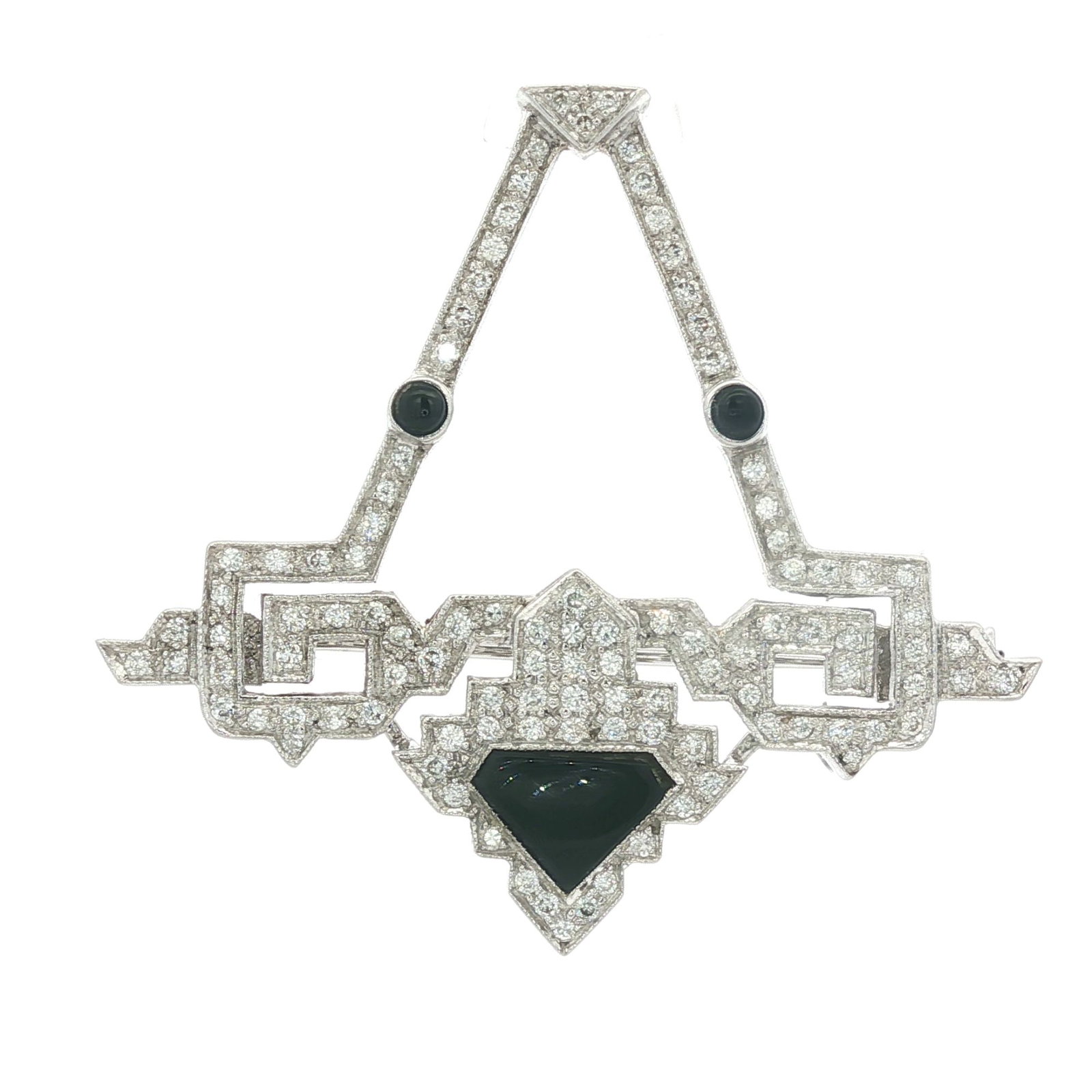 18K White Gold Art Deco Diamond & Onyx Brooch: 18K white gold Art Deco geometric brooch/dress clip with a central design in a stylized crest shape. The surface is encrusted with round shaped diamonds and features black onyx accents. Marked 750. Th