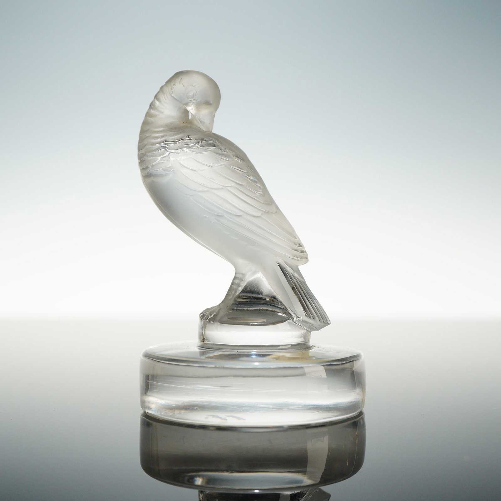 Lalique French Crystal Figurine, Turtle Dove: A small crystal figurine of a preening turtle dove, identified as the Tourterelle model, produced by Lalique France. The bird is depicted with its head turned back over its shoulder in a classic preen