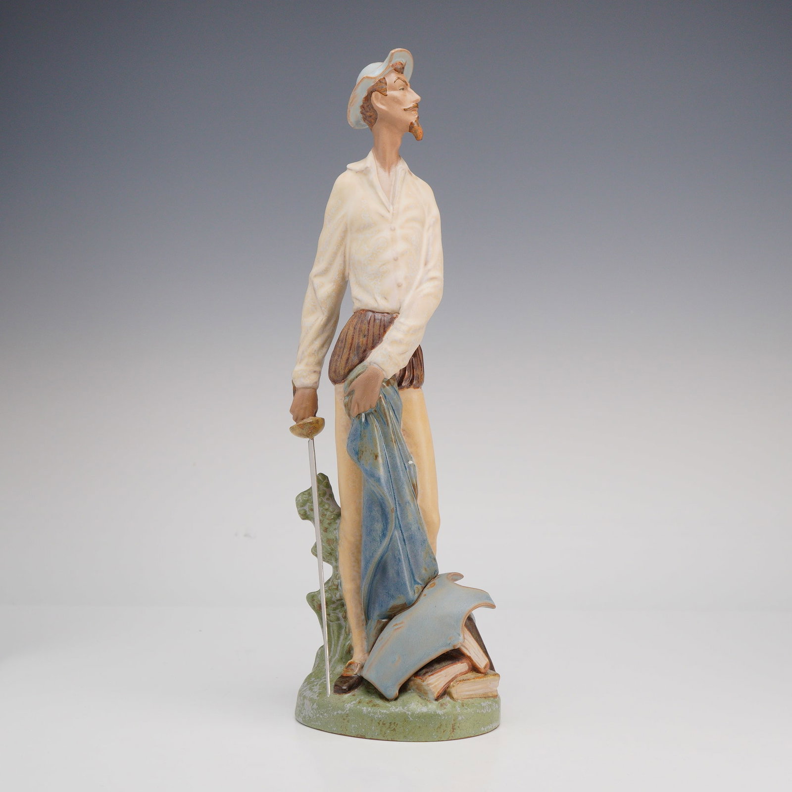 Lladro Gres Porcelain Don Quixote Standing Figurine Model 2265: A Lladro gres porcelain figurine depicting the literary character Don Quixote in a tall, slender standing pose, model number 2265. The figure is rendered with a matte finish in a palette of cream, bro