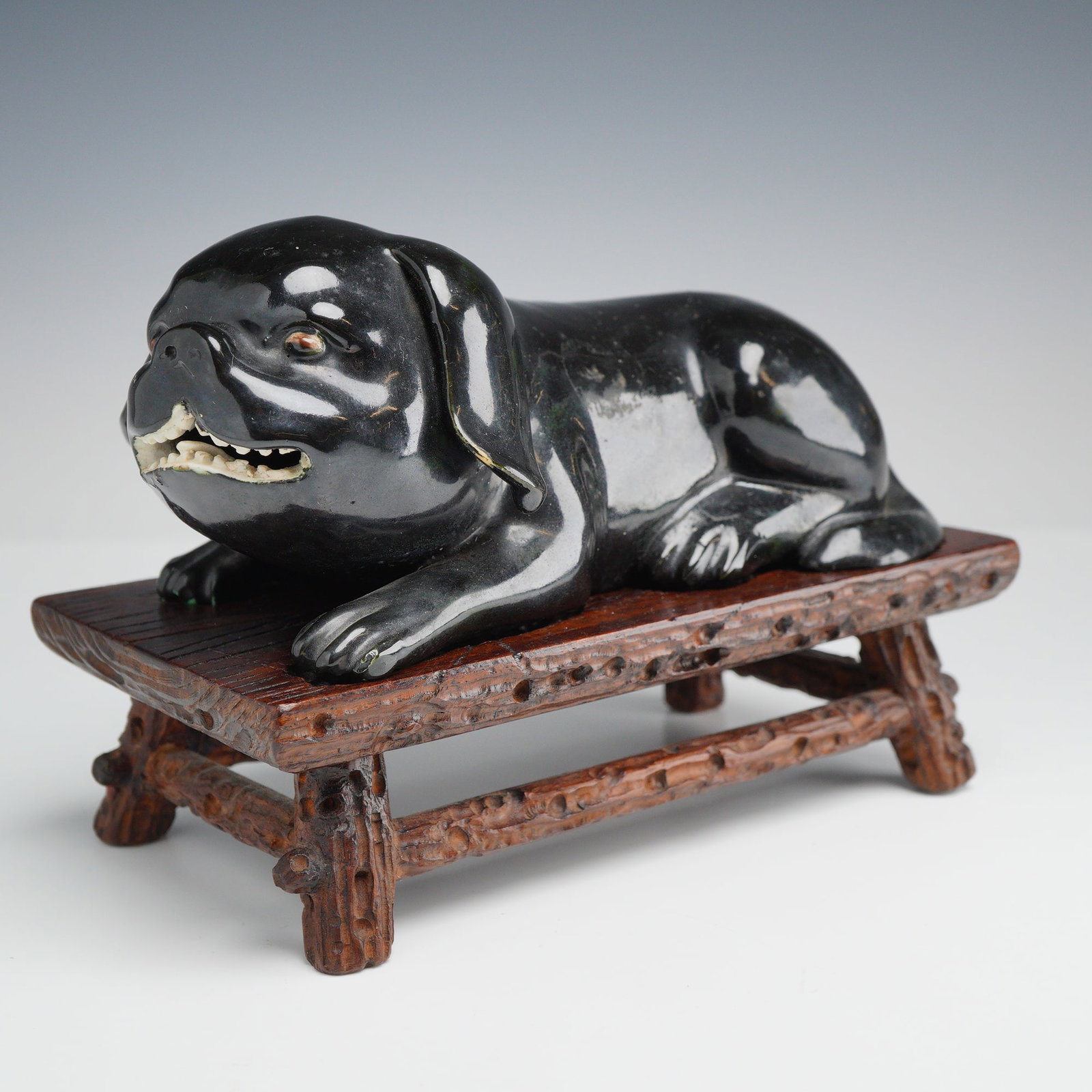Black Glazed Porcelain Figurine of a Reclining Pug with Carved Wooden Stand (1 of 4)