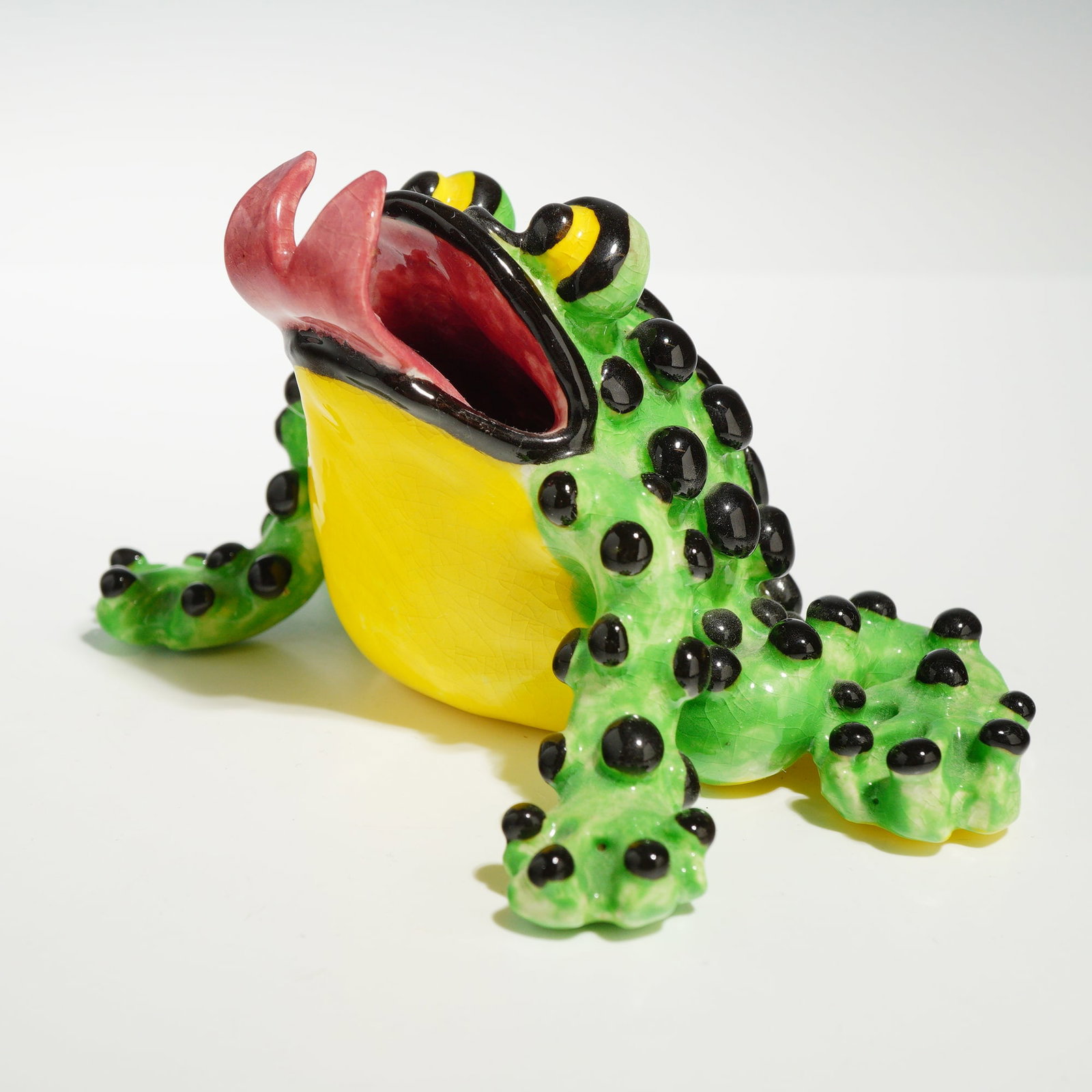 1993 M. Southwell Studio Pottery Frog Figurine: This is an original work of studio pottery depicting a stylized frog, signed by the artist M. Southwell and dated 1993. The hand-molded ceramic figurine is rendered in a crouching posture with a wide-