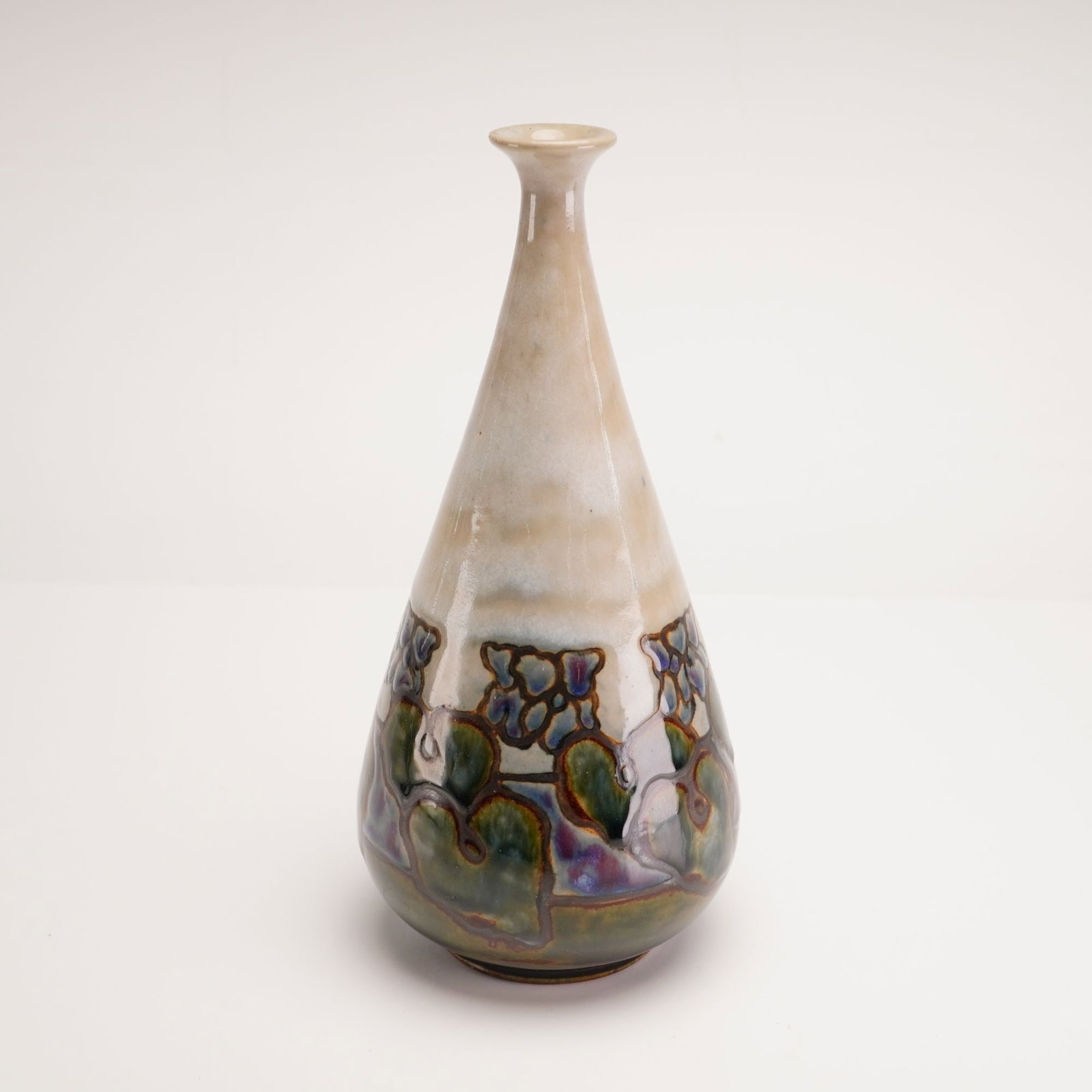 Royal Doulton Lambeth Art Nouveau Stoneware Bud Vase: This Art Nouveau stoneware vase was produced by Royal Doulton at the Lambeth factory in London, England. The vessel features a bulbous base that tapers sharply into a long, slender neck with a small, 
