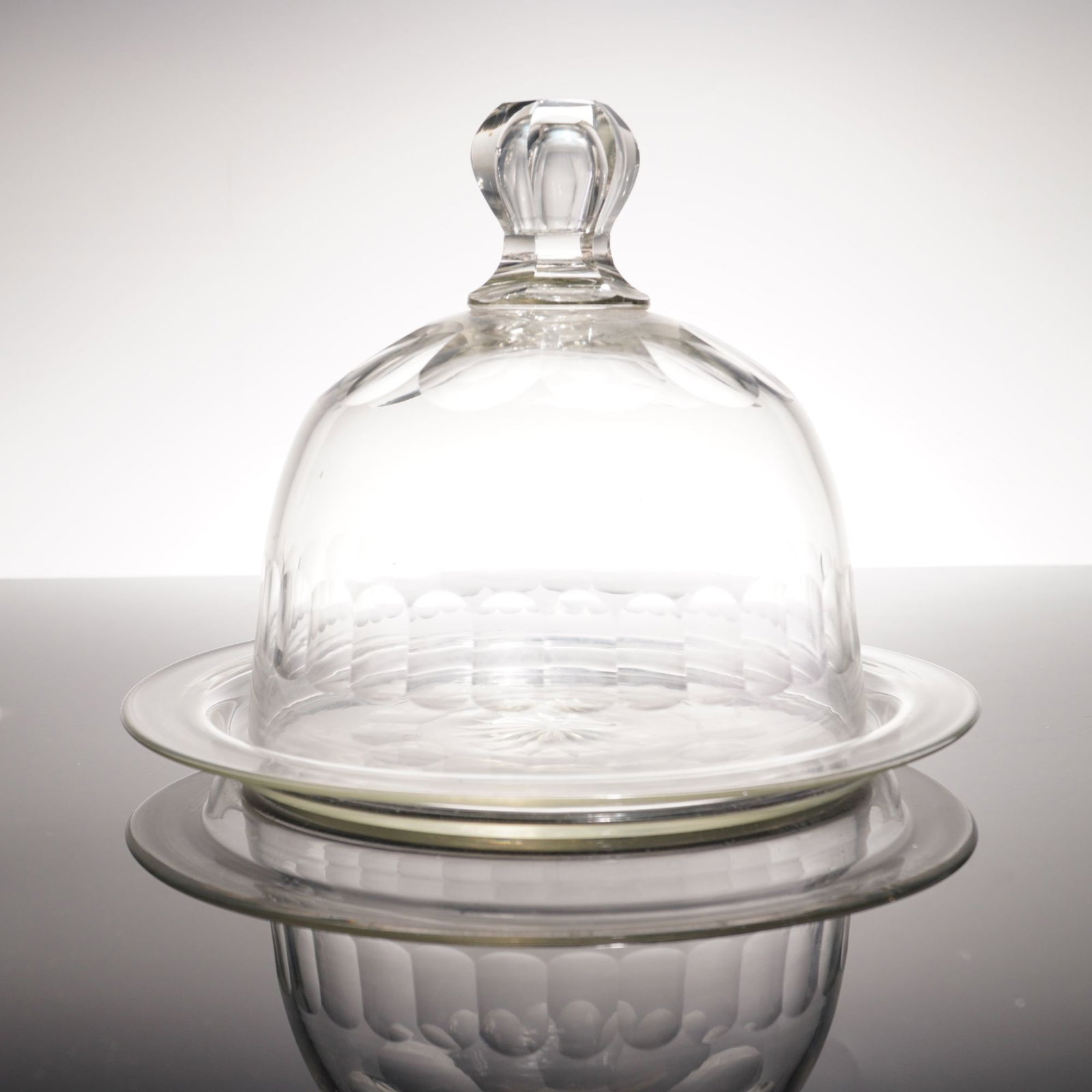 Vintage Clear Glass Cheese Dome and Underplate: A two-piece covered glass plate set consisting of a bell-shaped dome and a matching circular underplate. Features wheel-cut decoration throughout. The dome is topped with a multi-faceted knob finial a