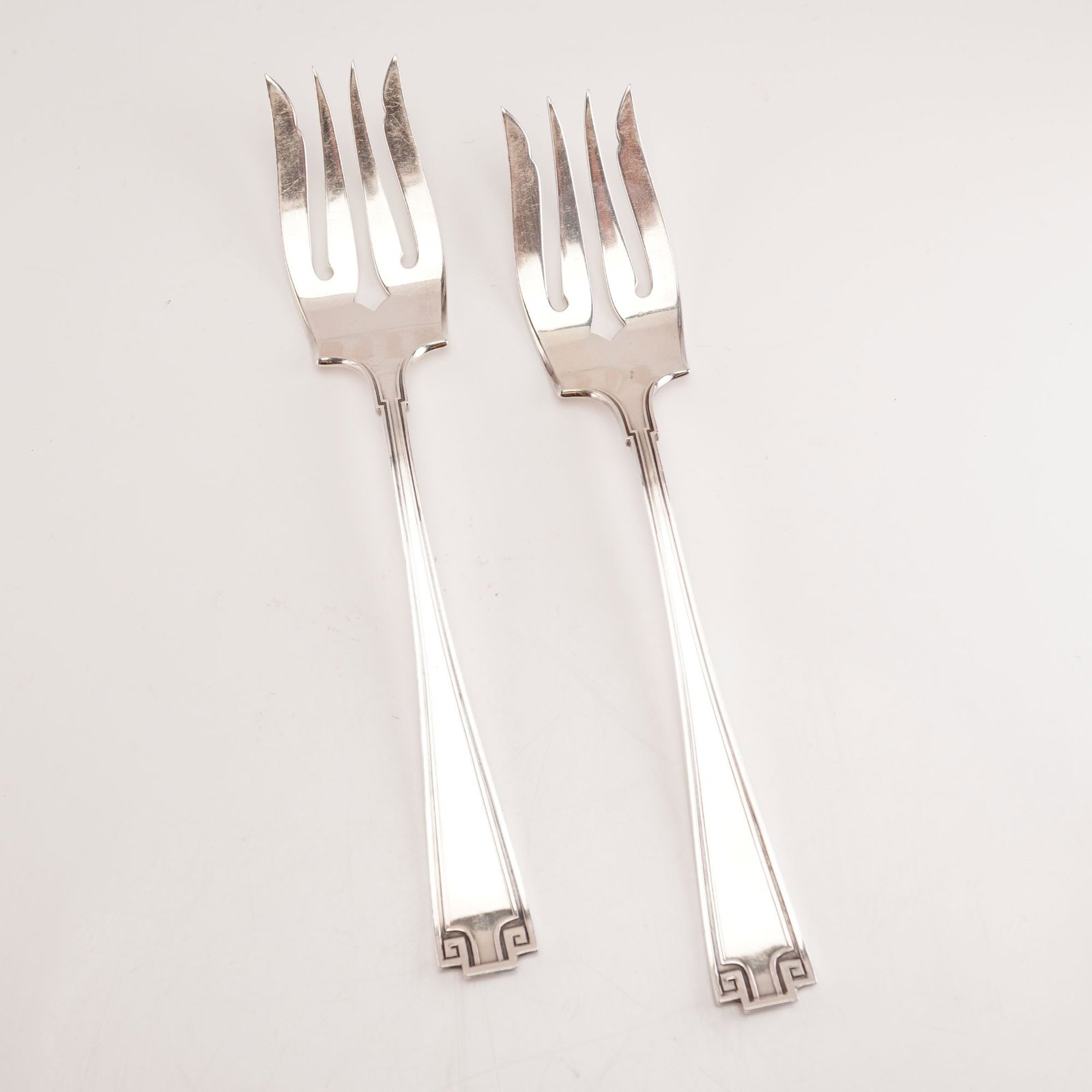 2pc Gorham Sterling Silver Salad Forks, Etruscan: Featured is a set of two Gorham sterling silver salad forks in the celebrated Etruscan pattern. Produced from 1913 to 1991, the pattern is characterized by its Greco-Roman revival styling with symmetr