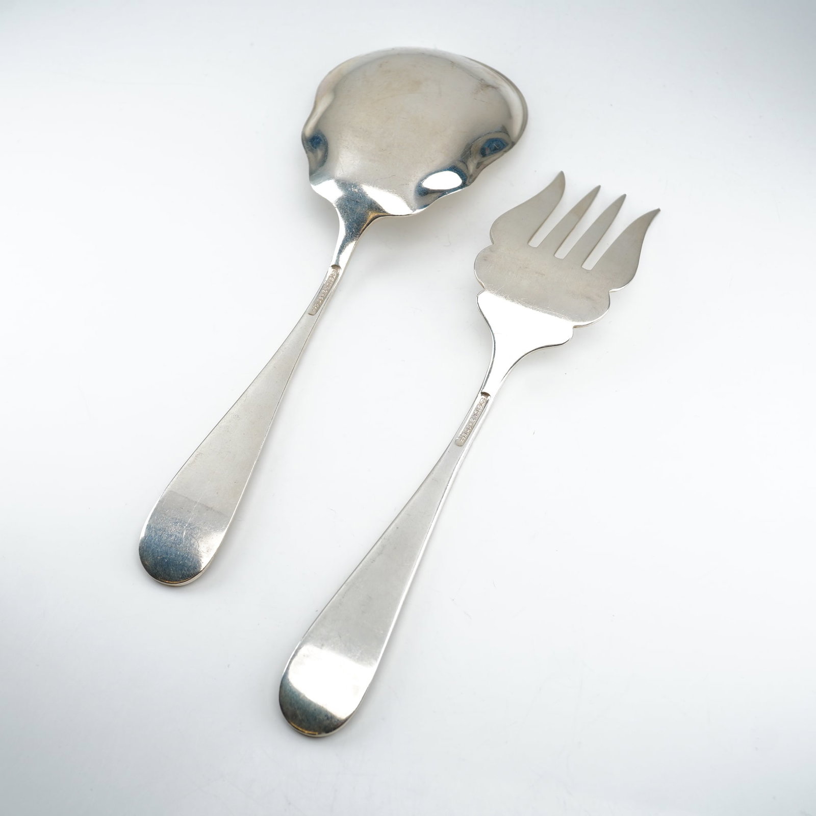 2pc Kirk Stieff Sterling Silver Cold Meat Fork and Salad Spoon, Stieff Rose: A two-piece serving assortment in the celebrated Stieff Rose pattern by Kirk Stieff, introduced in 1892. Comprising a cold meat fork and salad serving spoon, each piece features an ornate sterling sil