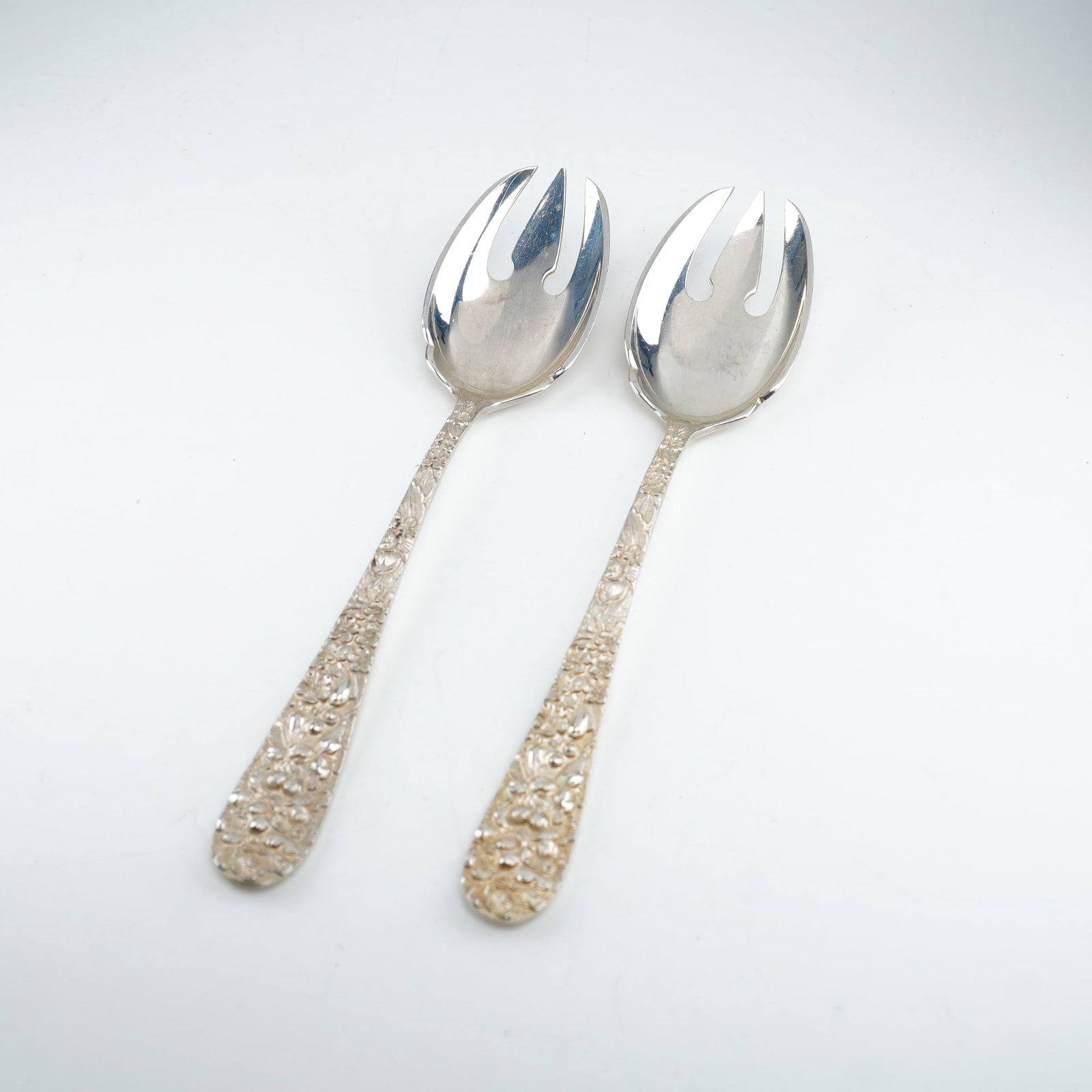 2pc Kirk Stieff Sterling Silver Ice Cream Forks, Stieff Rose: Matched pair of frozen dessert forks featuring the classic 1892 Stieff Rose design. Each fork has an ornate sterling silver handle with detailed floral repousse decoration in raised relief. Marked Ste