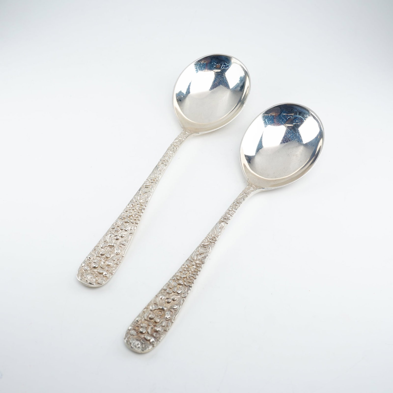 2pc Kirk Stieff Sterling Silver Round Bowl Soup Spoons, Stieff Rose: Pair of Kirk Stieff sterling silver round bowl soup spoons in the iconic Stieff Rose pattern. Dating back to 1892, this pattern is distinguished by finely detailed floral repousse ornamentation crafte