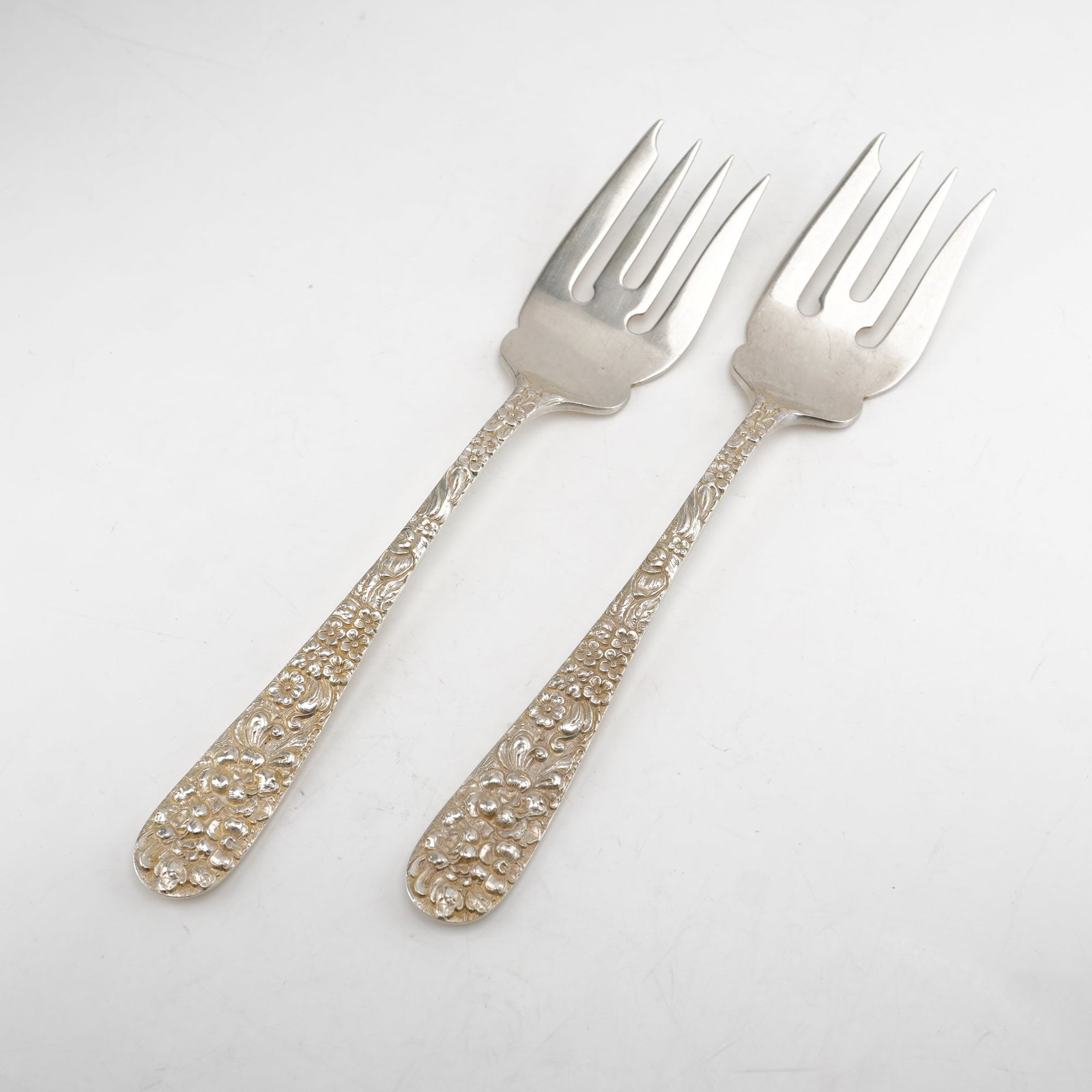 2pc Kirk Stieff Sterling Silver Salad Forks, Stieff Rose: Set of two salad forks in the classic Stieff Rose pattern by Kirk Stieff, a design dating back to 1892. Each fork features a sterling silver handle embellished with detailed floral repousse work, exec