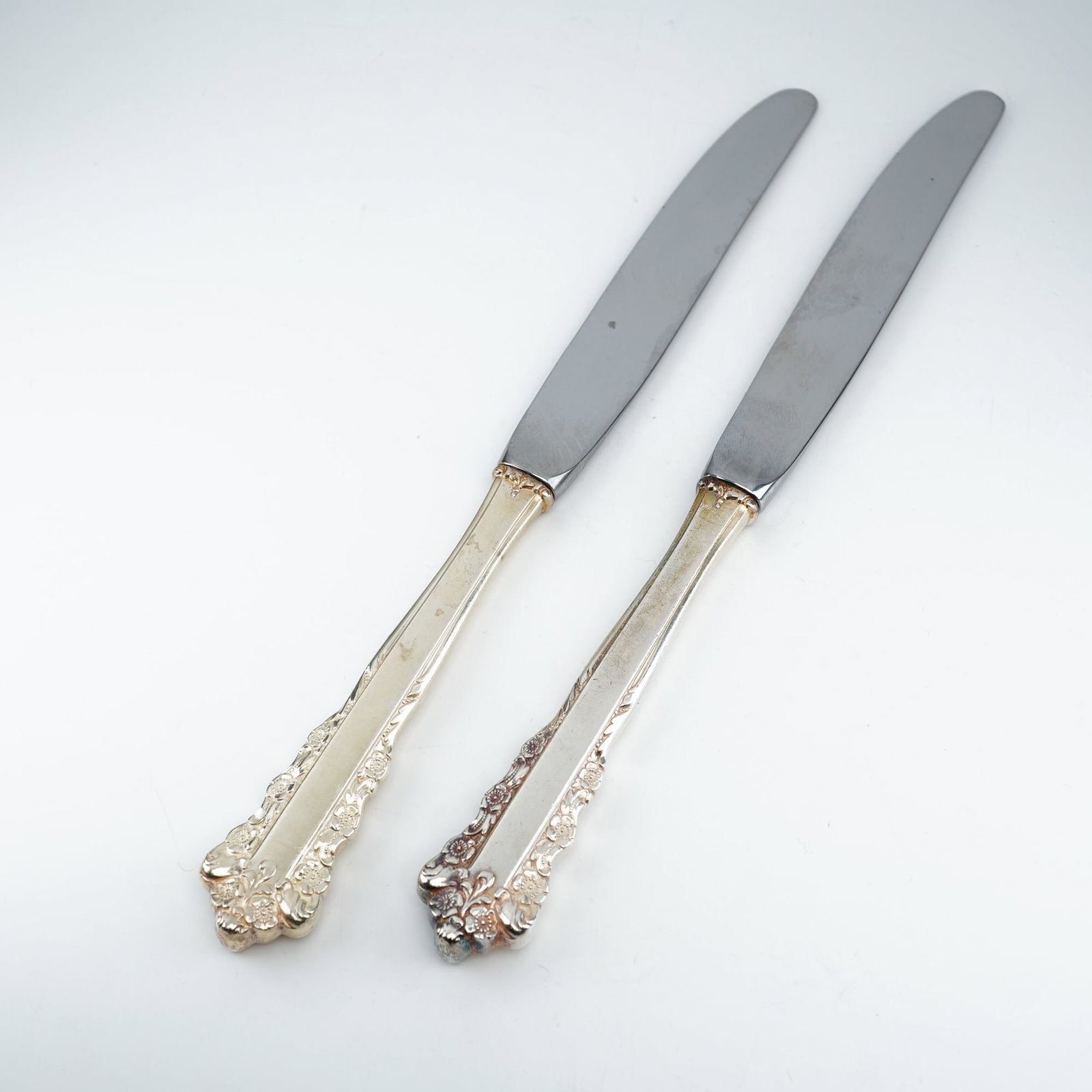 2pc Lunt Sterling Silver and Stainless Steel Dinner Spreaders, Belle Meade: Crafted by Lunt Silversmiths circa 1967"1997, this pair showcases the Belle Meade pattern with richly detailed Rococo-style ornamentation. The sterling silver handles feature applied floral clusters, 