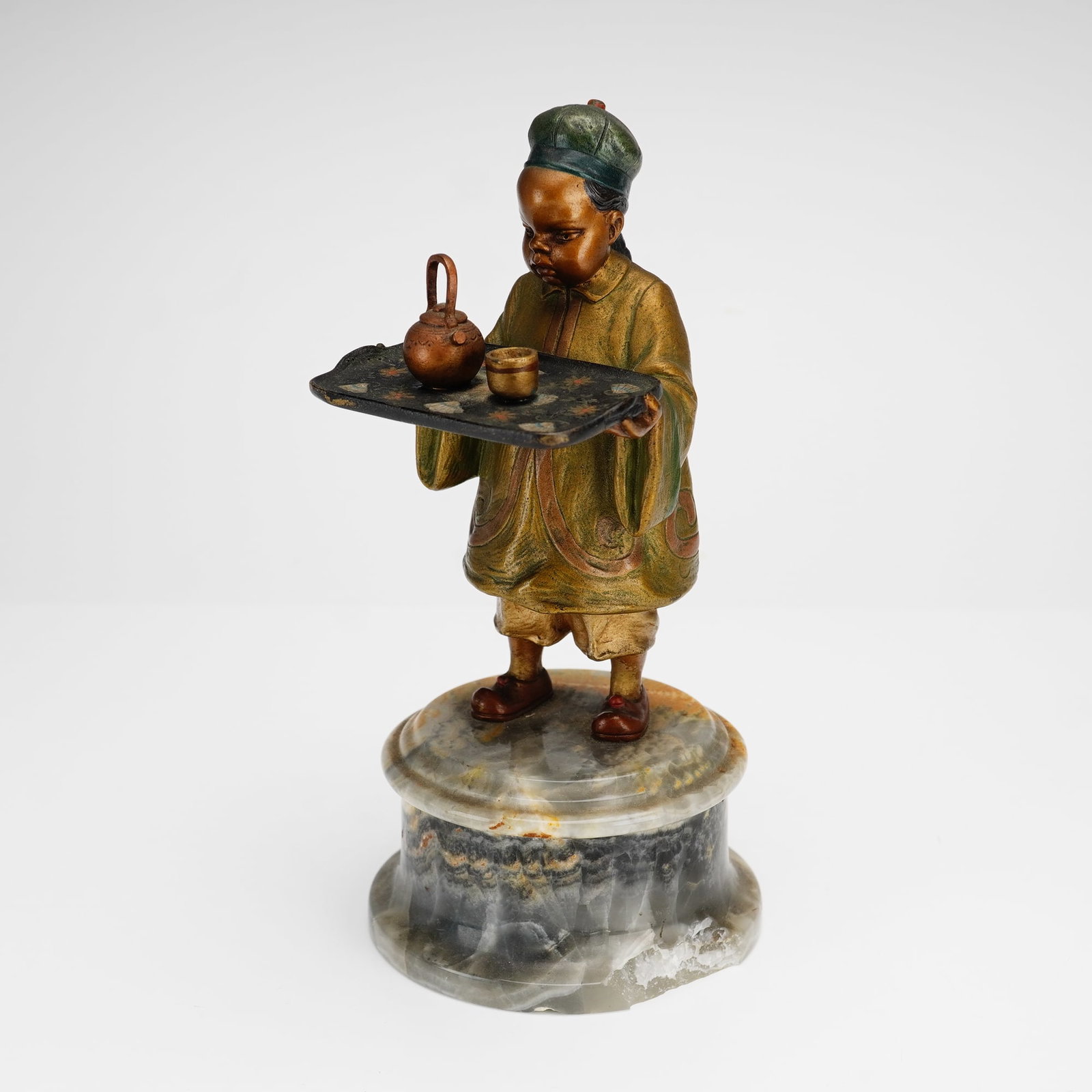 Cold-Painted Bronze Figurine of a Chinese Attendant on Onyx Base: This cold-painted bronze figurine, executed in the style associated with late 19th-century Viennese foundries, depicts a young Chinese attendant in traditional Qing dynasty-style attire. The figure is