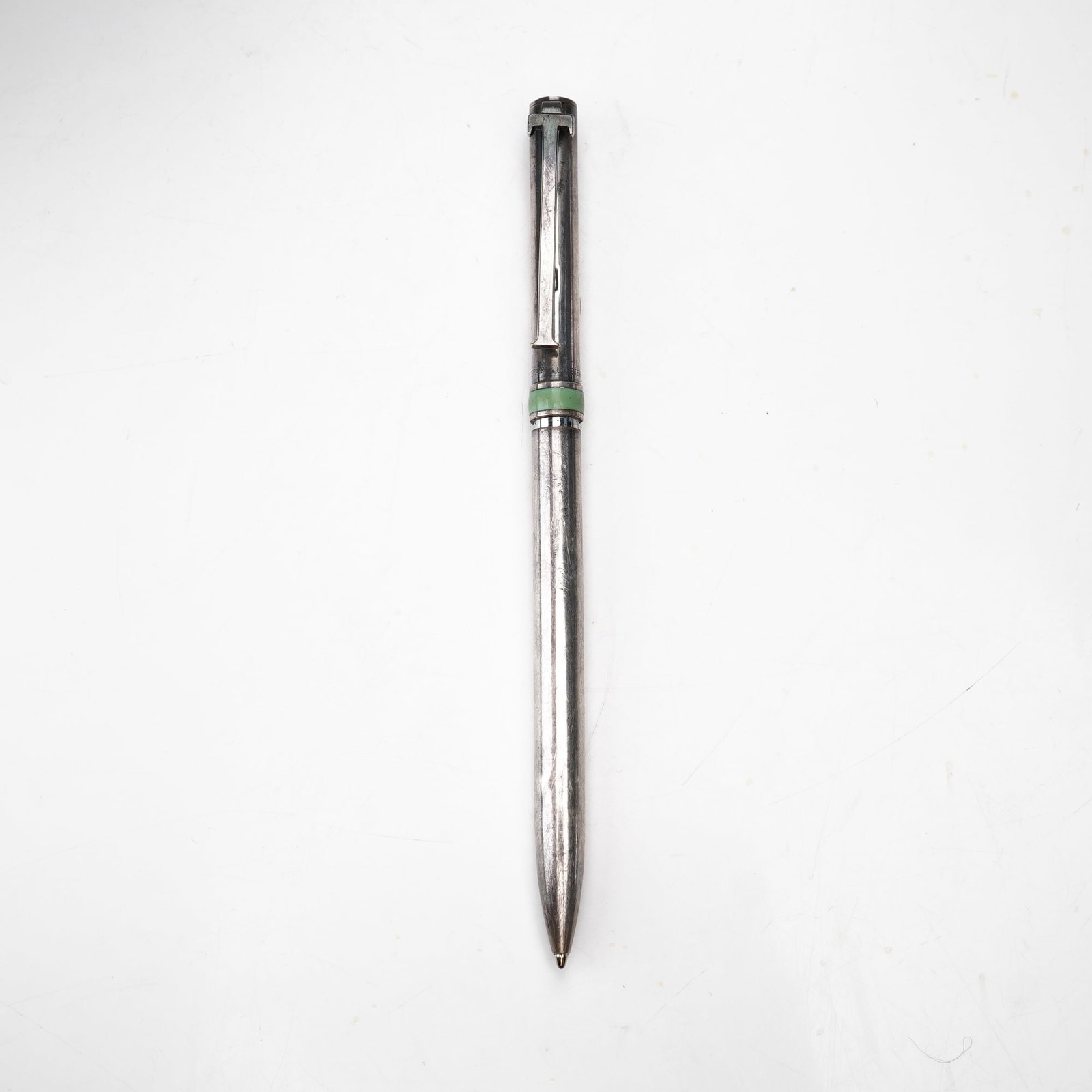 Tiffany & Co. Sterling Silver T-Clip Ballpoint Pen: A vintage Tiffany & Co. T-Clip retractable ballpoint pen. The writing instrument is constructed with a sterling silver barrel and cap, separated by a central decorative green band, likely composed of 